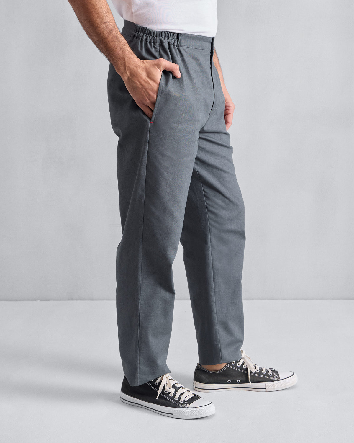 Side view of grey Meadow Pants worn by a person, hand in the pocket.