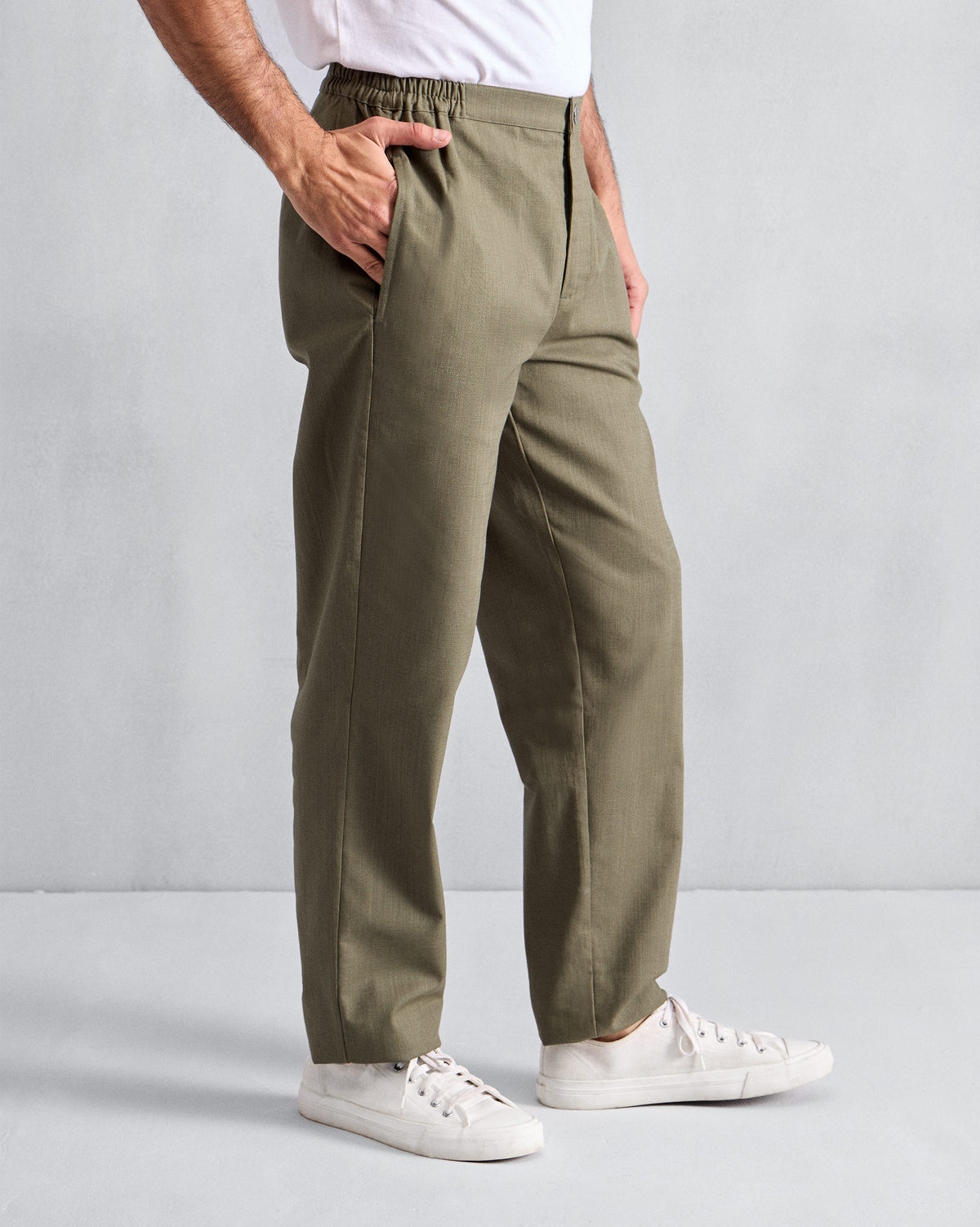 Side view of olive Meadow Pants with a relaxed straight leg.