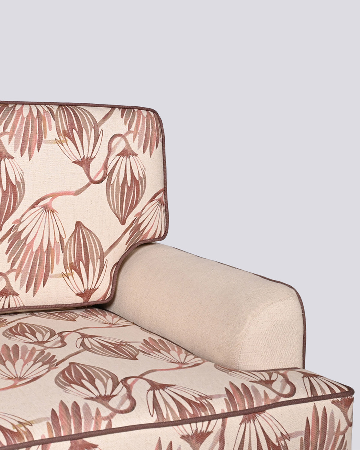 Close-up of Field Sofa upholstery with botanical print and dark piping.