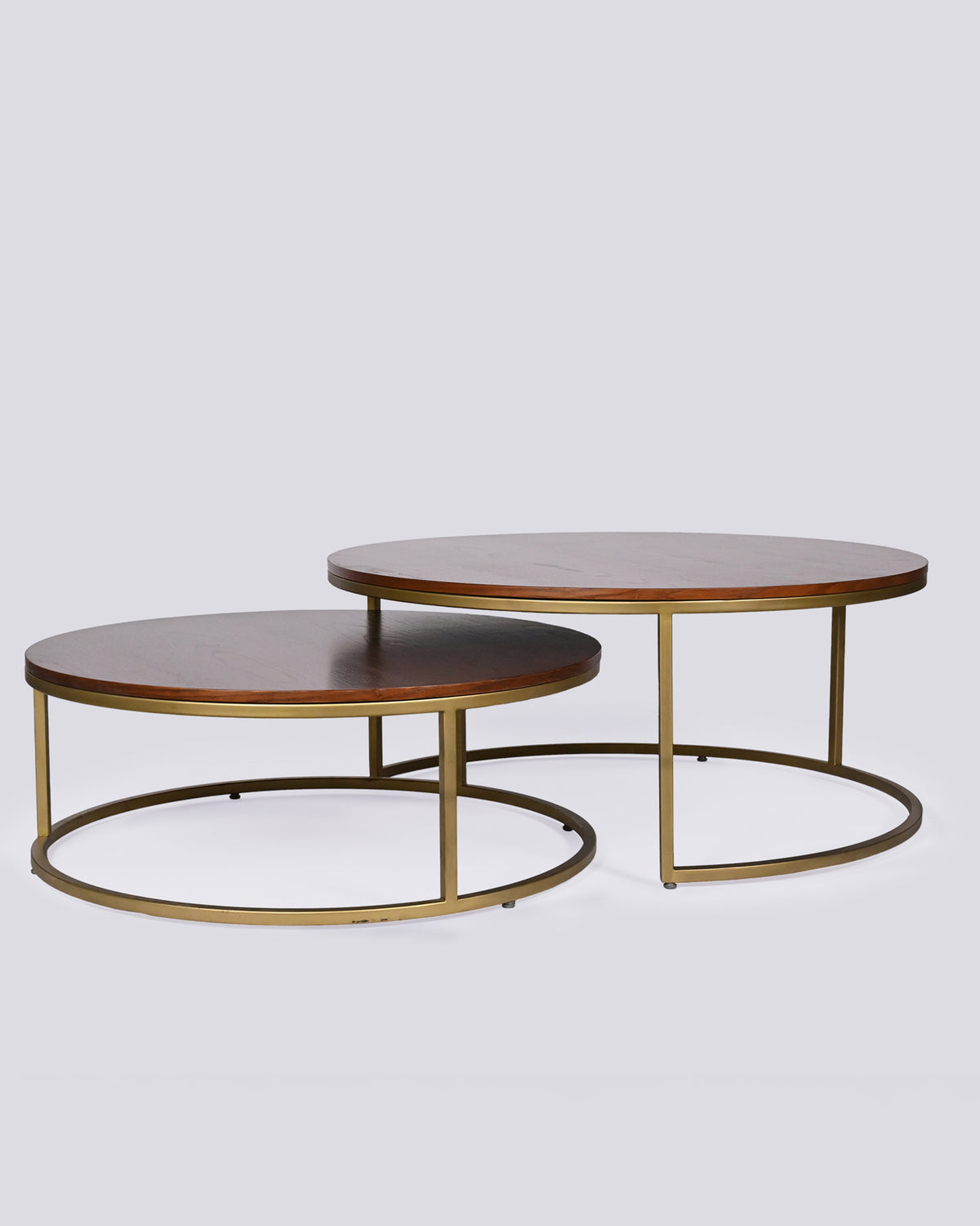 Pair of Orbit center tables with round wood tops and brass frames nested together.
