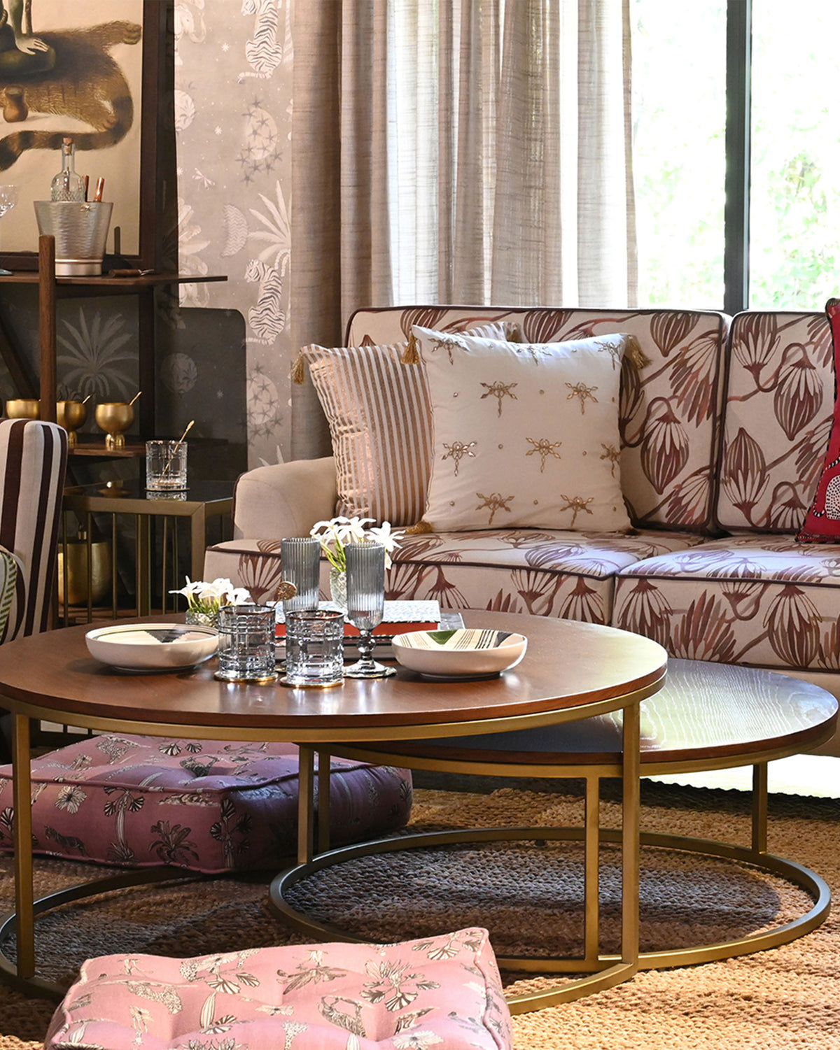 Orbit nesting center tables styled in a living room with sofa and cushions.