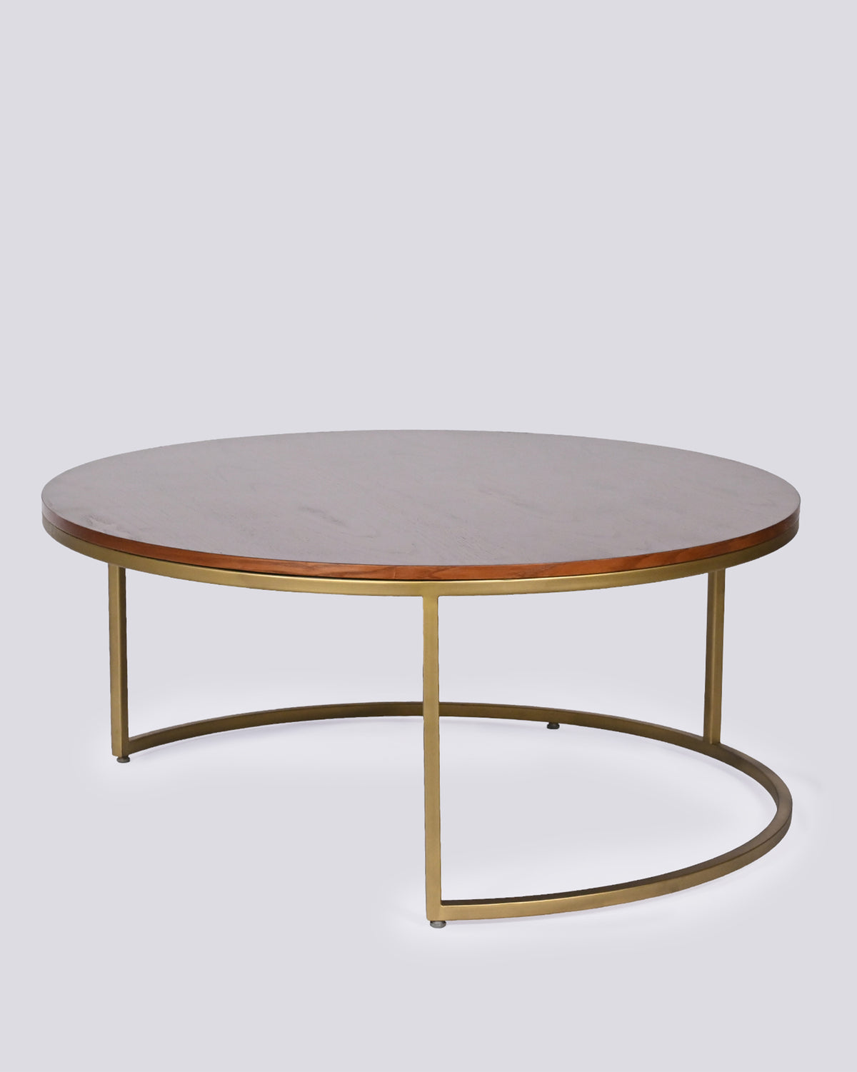 Orbit center table with a dark wood top and slim brass metal legs.