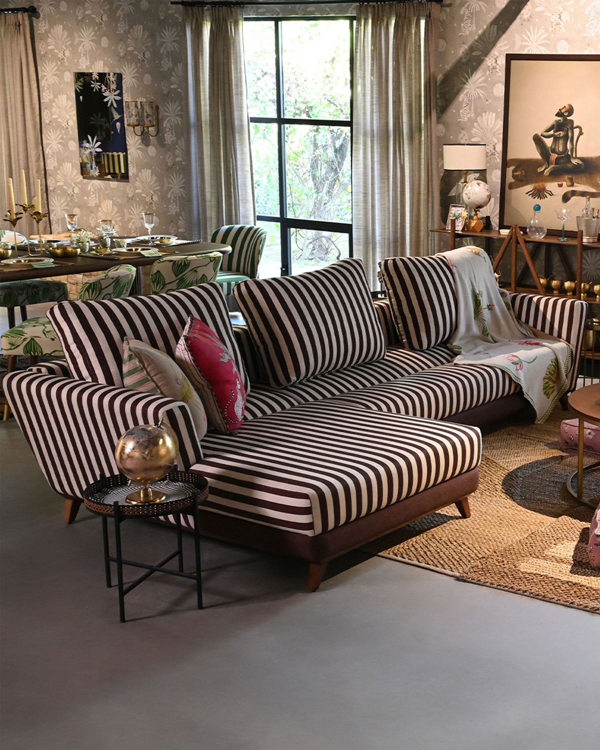 Brown and cream striped Vale sofa styled in a living room with pillows and a throw.