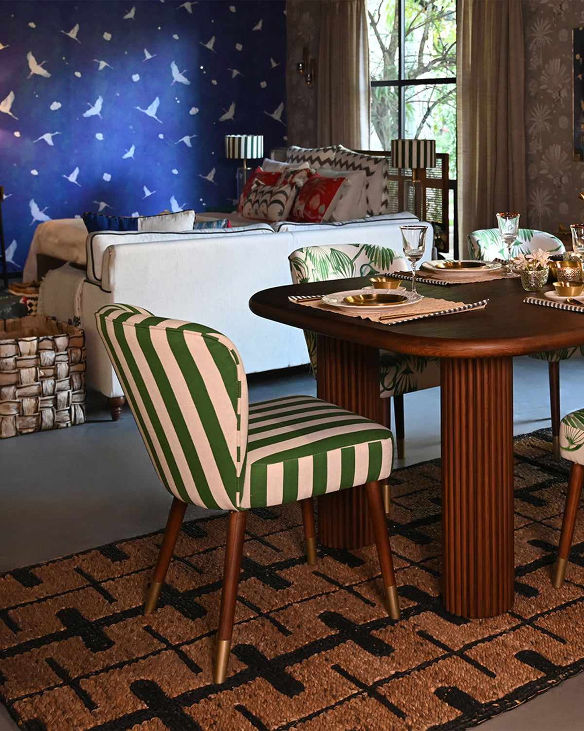 Rain dining chair in green stripes at a set wooden dining table.