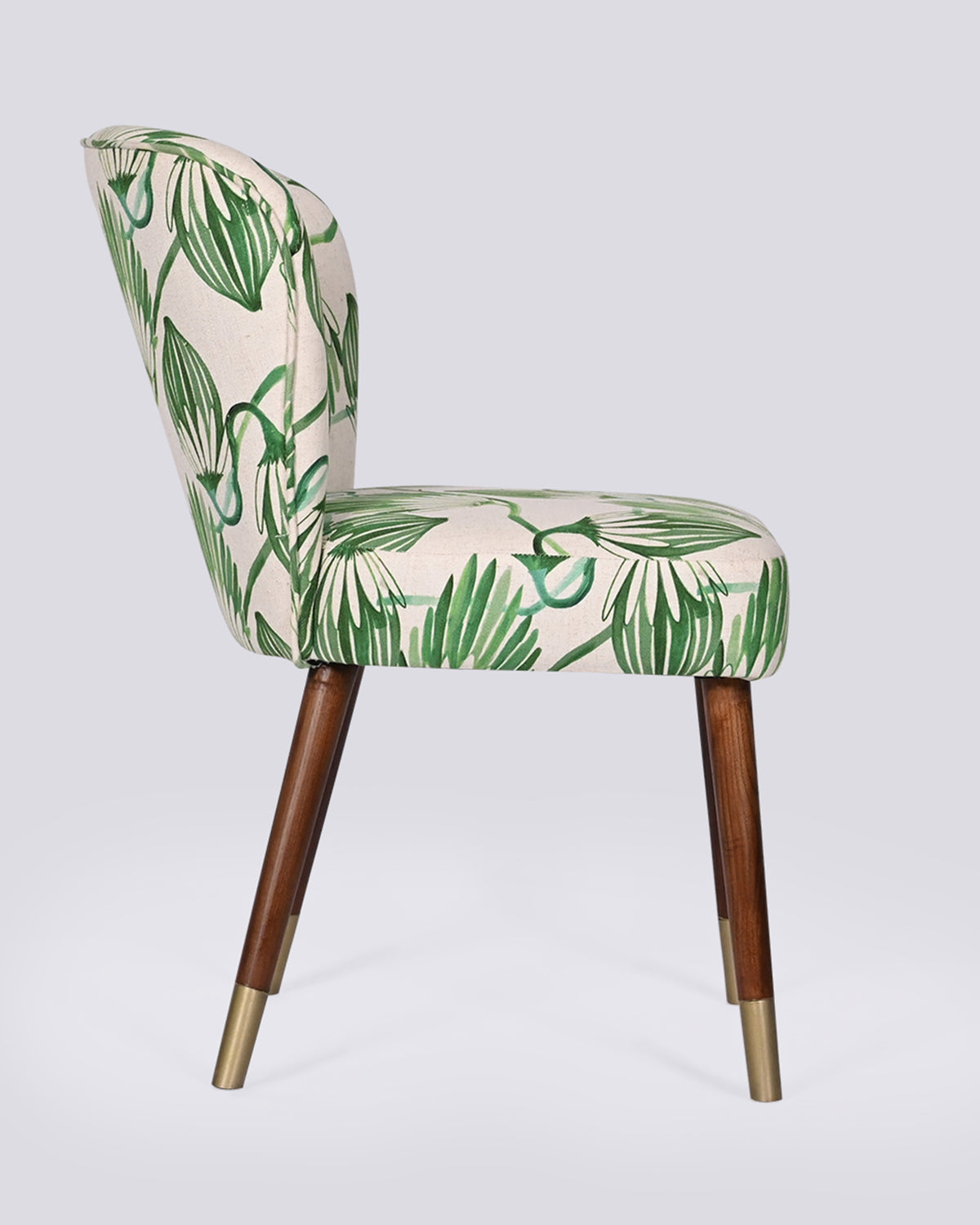 Side view of the Breeze Dining Chair with a curved back and brass-tipped legs.