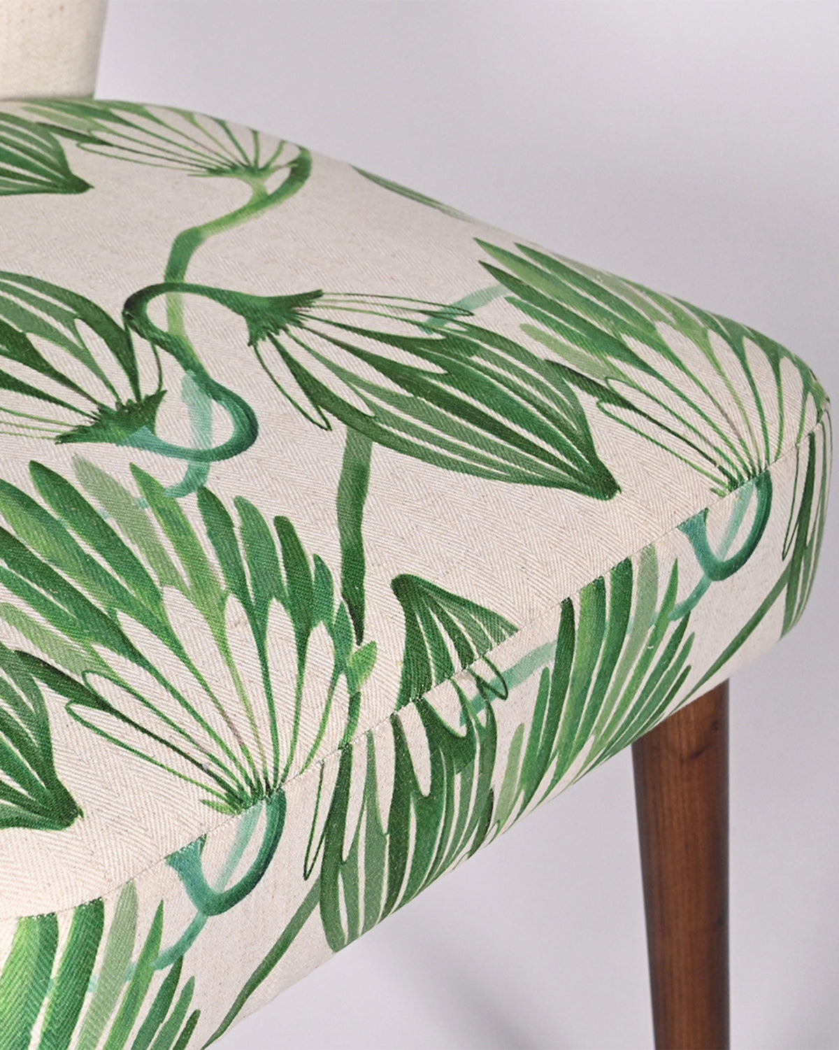 Close-up of green blooms fabric on the Breeze Dining Chair seat.