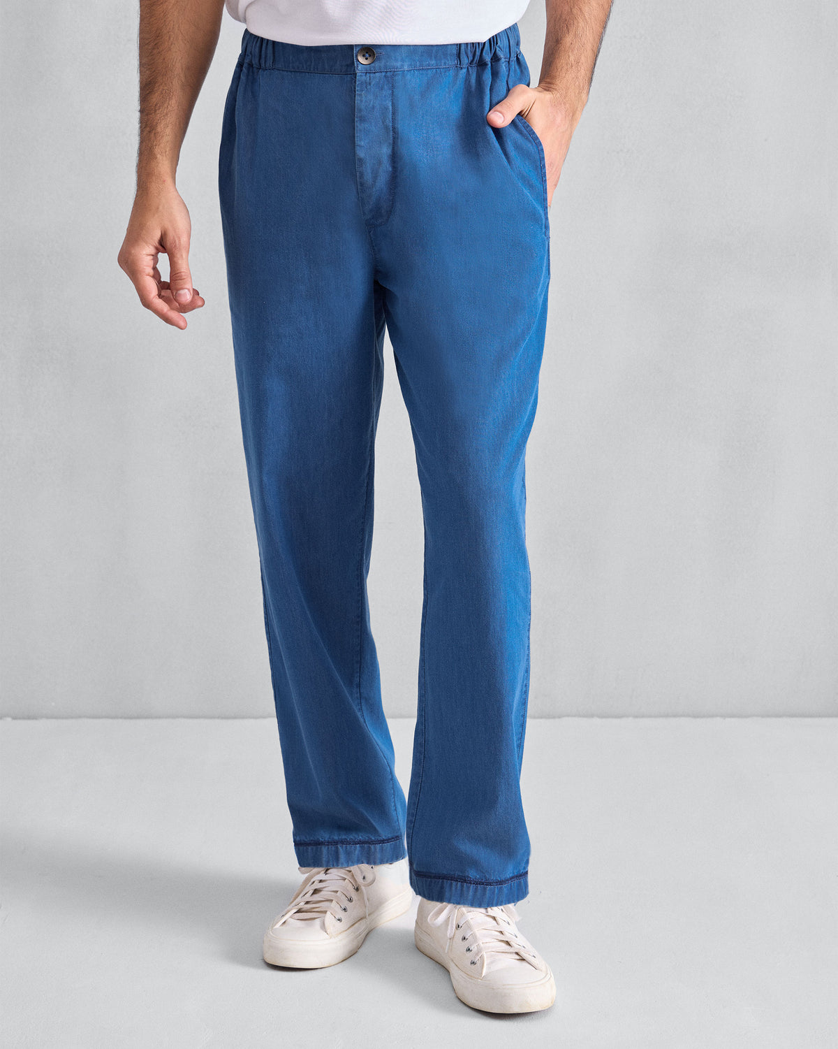 Person wearing denim blue Meadow Pants with a straight leg.