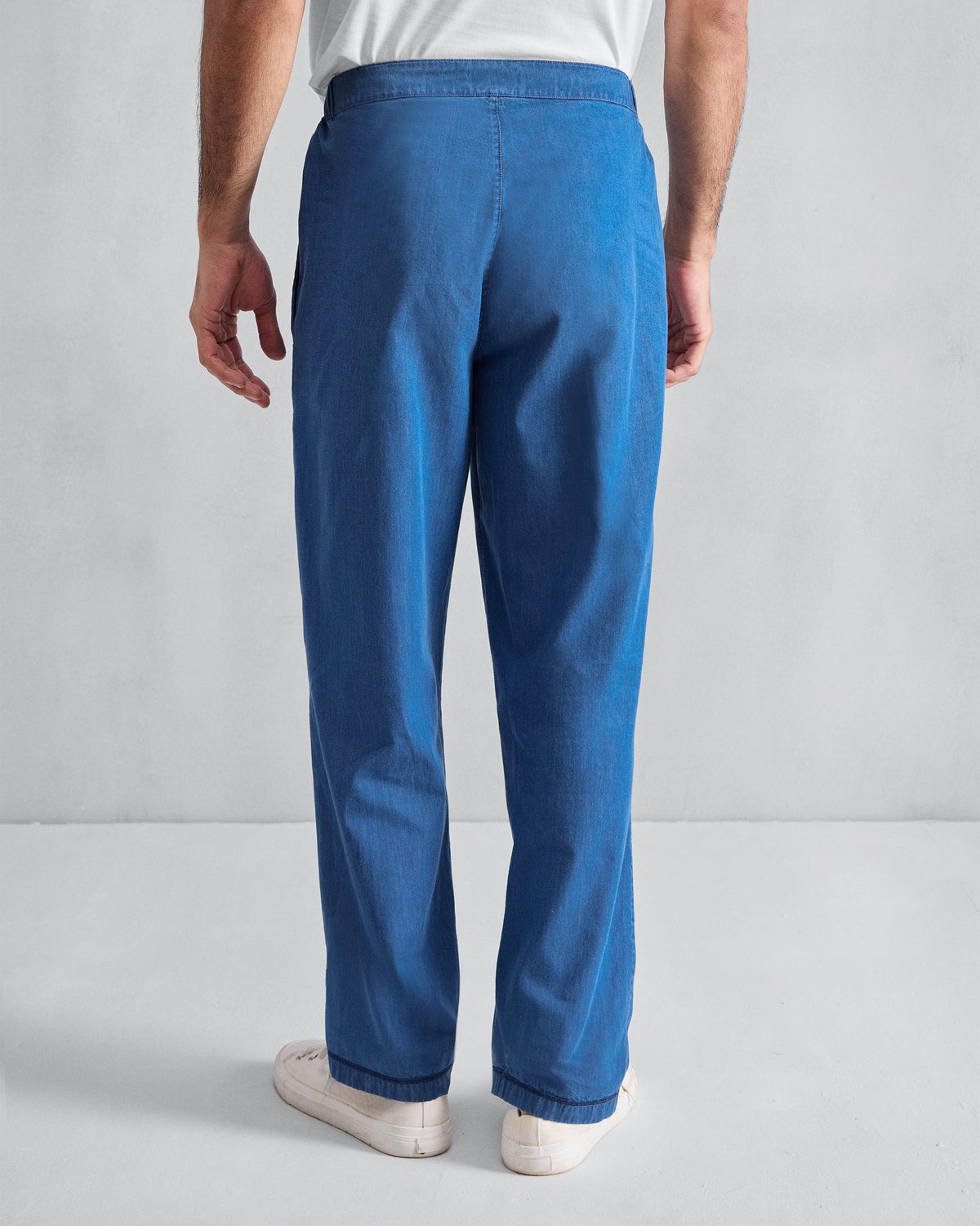 Back of denim blue Meadow Pants with an elasticated waist.