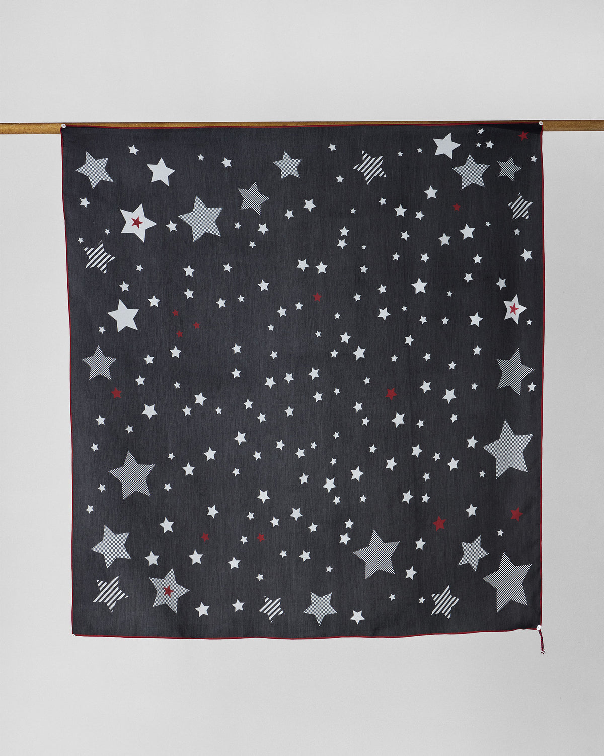 Starry Night Scarf in black with scattered white, grey and red stars.