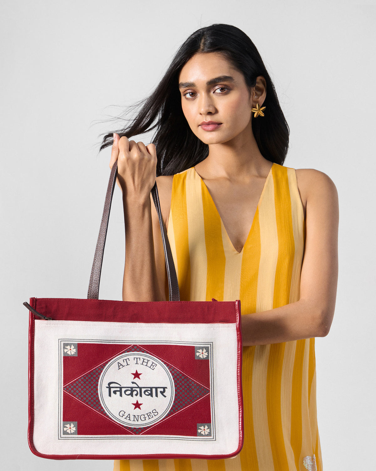 Ivory and red Ganges tote with an At the Ganges stamp graphic.