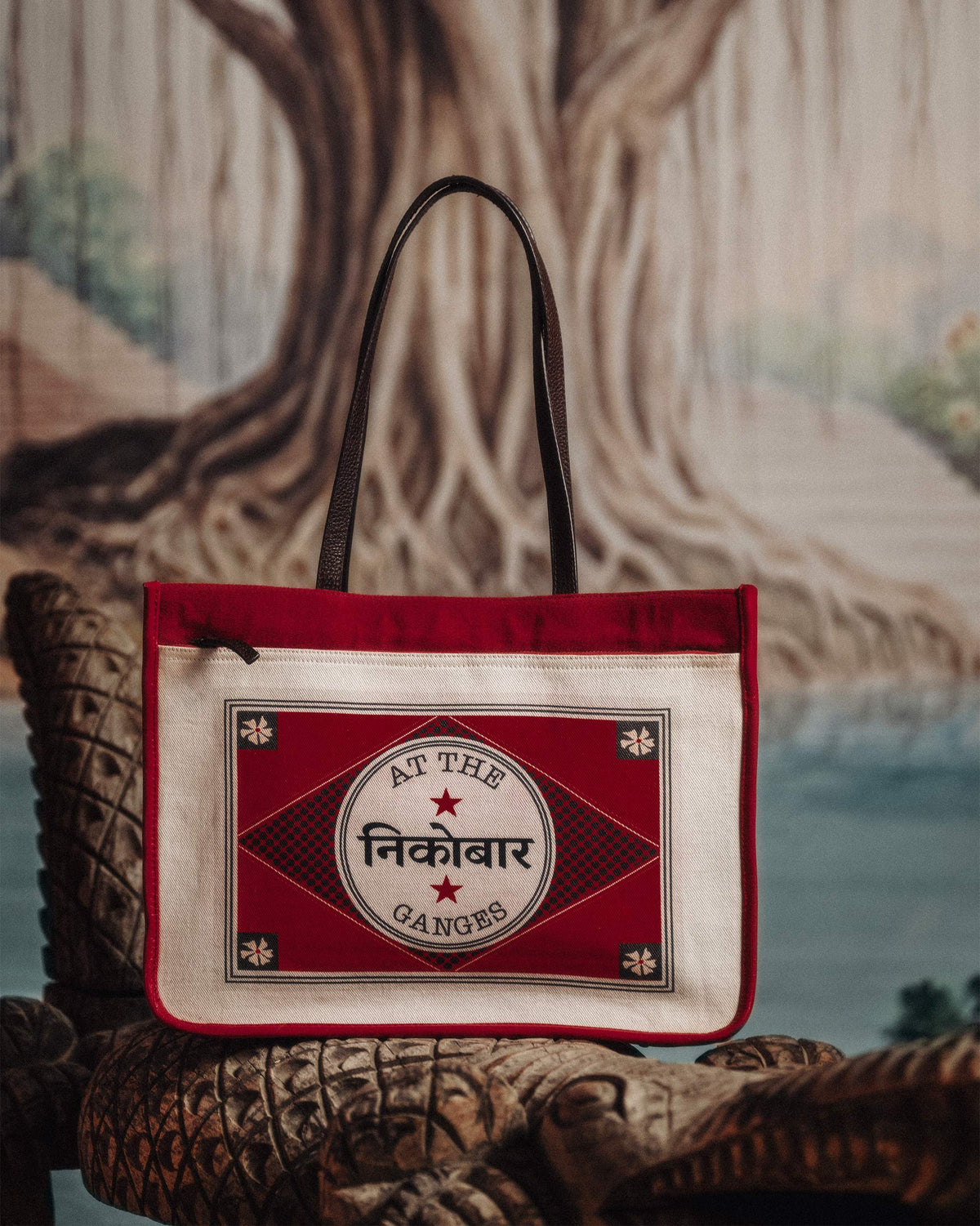 Ivory and red Ganges tote with an At the Ganges stamp graphic.
