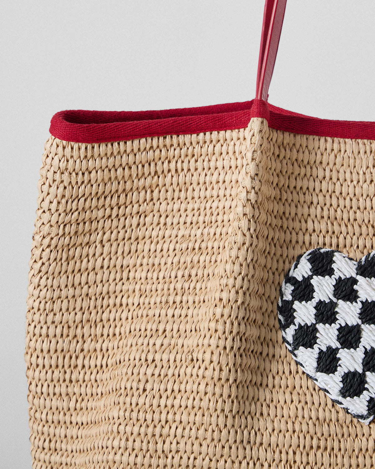 Close-up of the checkered heart on a Dil Woven Tote.