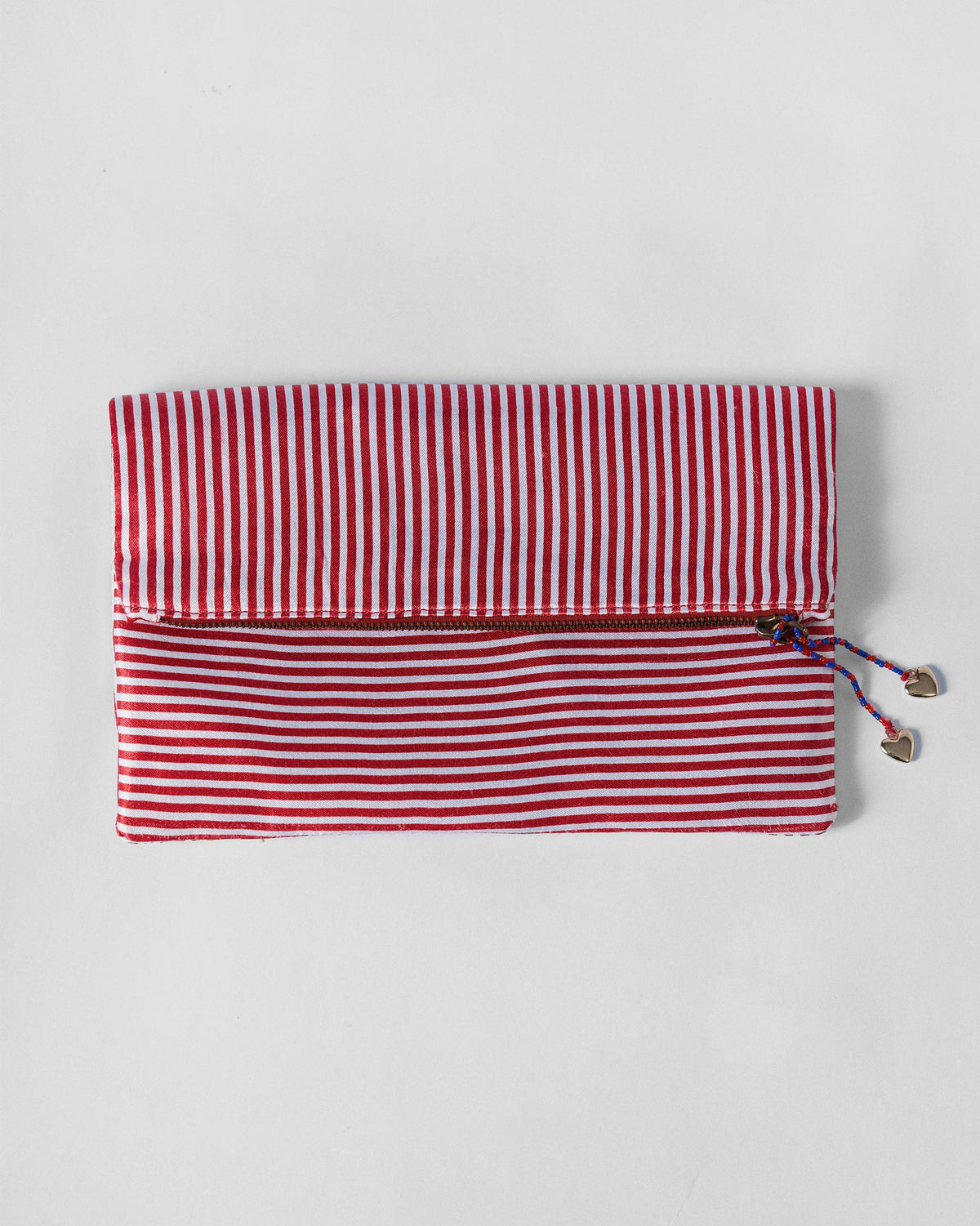Fold Over Clutch in red and ivory stripes with heart-tipped zip pulls.