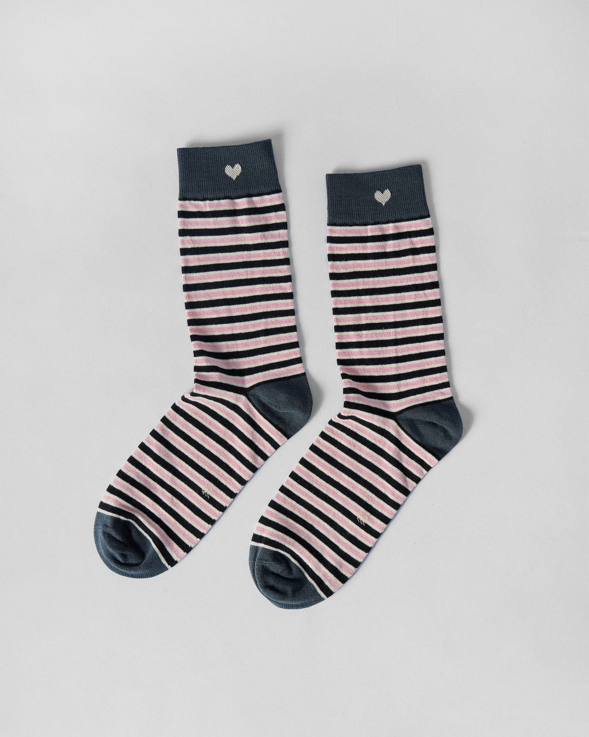 Pair of Candy Stripe socks in charcoal and pink stripes, laid flat.