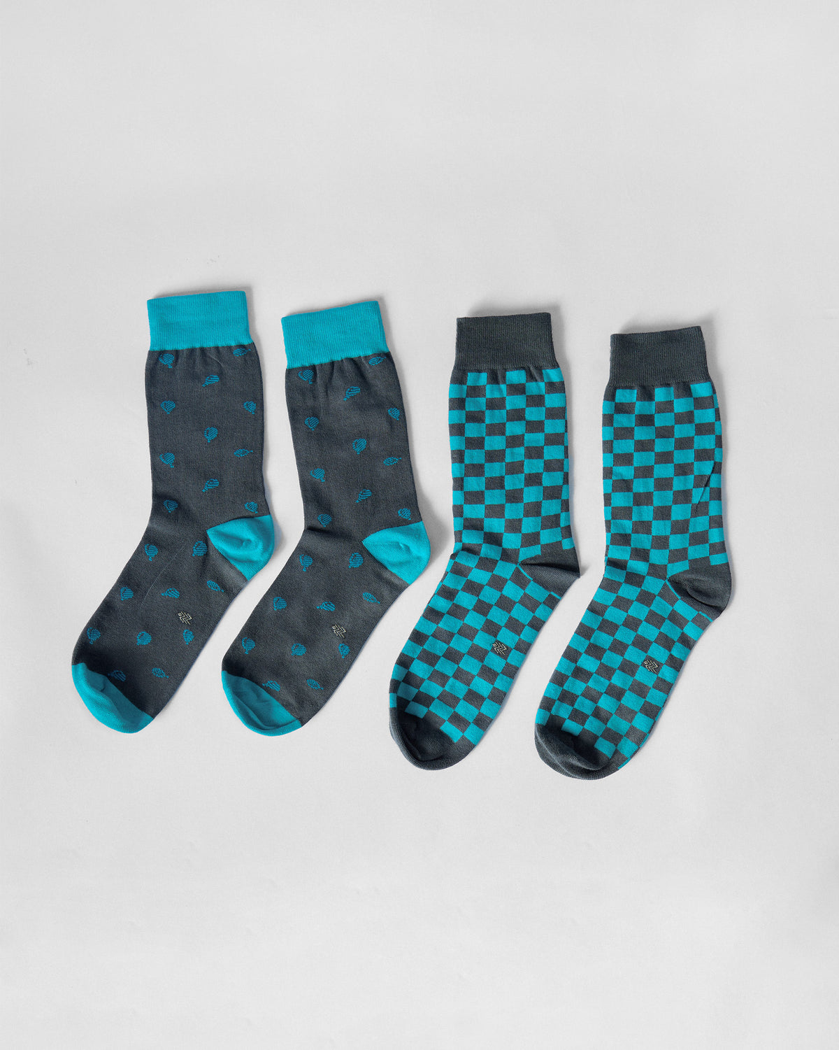 Pair of ice blue and charcoal Tile Pop Socks showing motif and checkerboard designs.