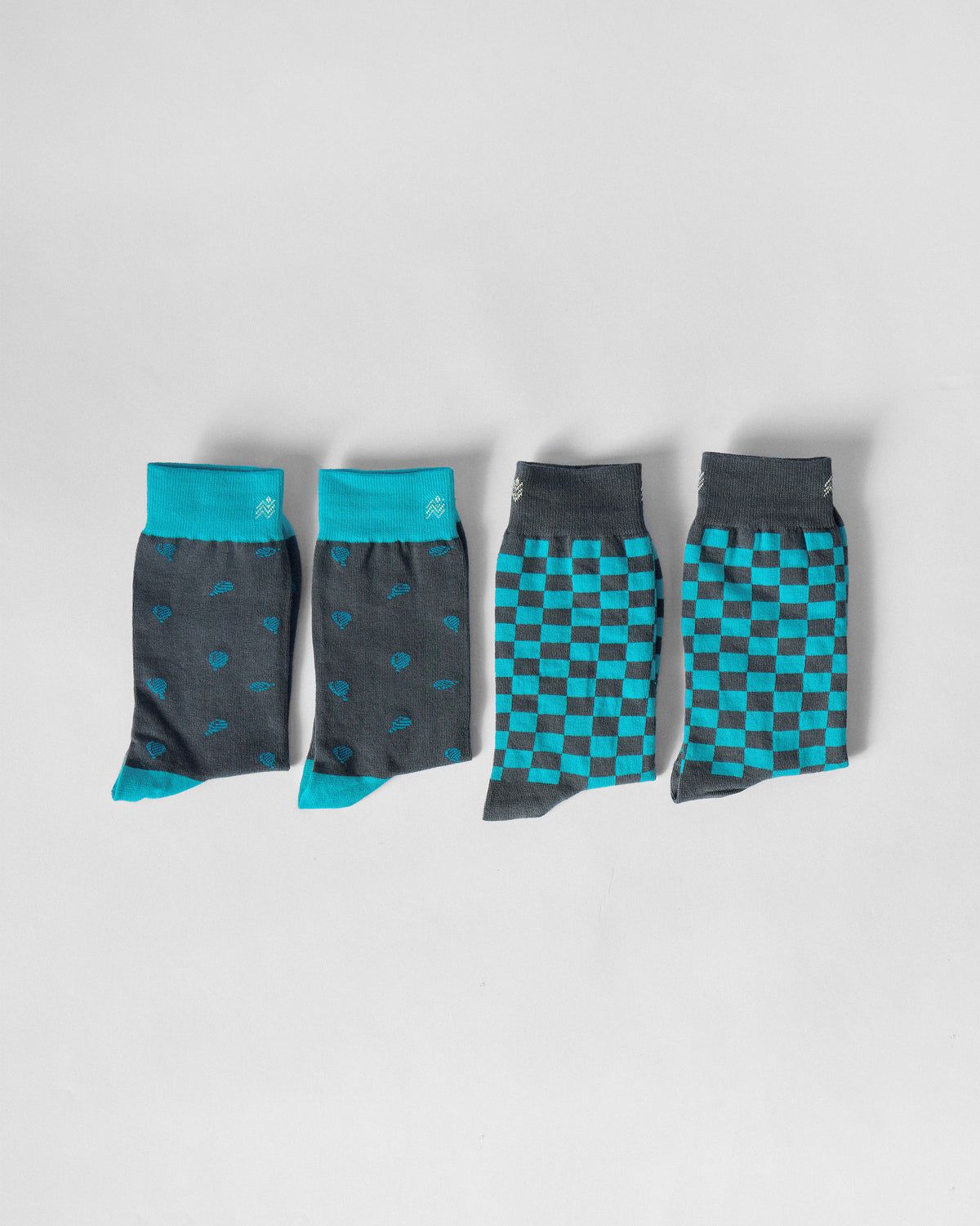 Tile Pop Socks in charcoal motif and teal checkerboard patterns laid flat.
