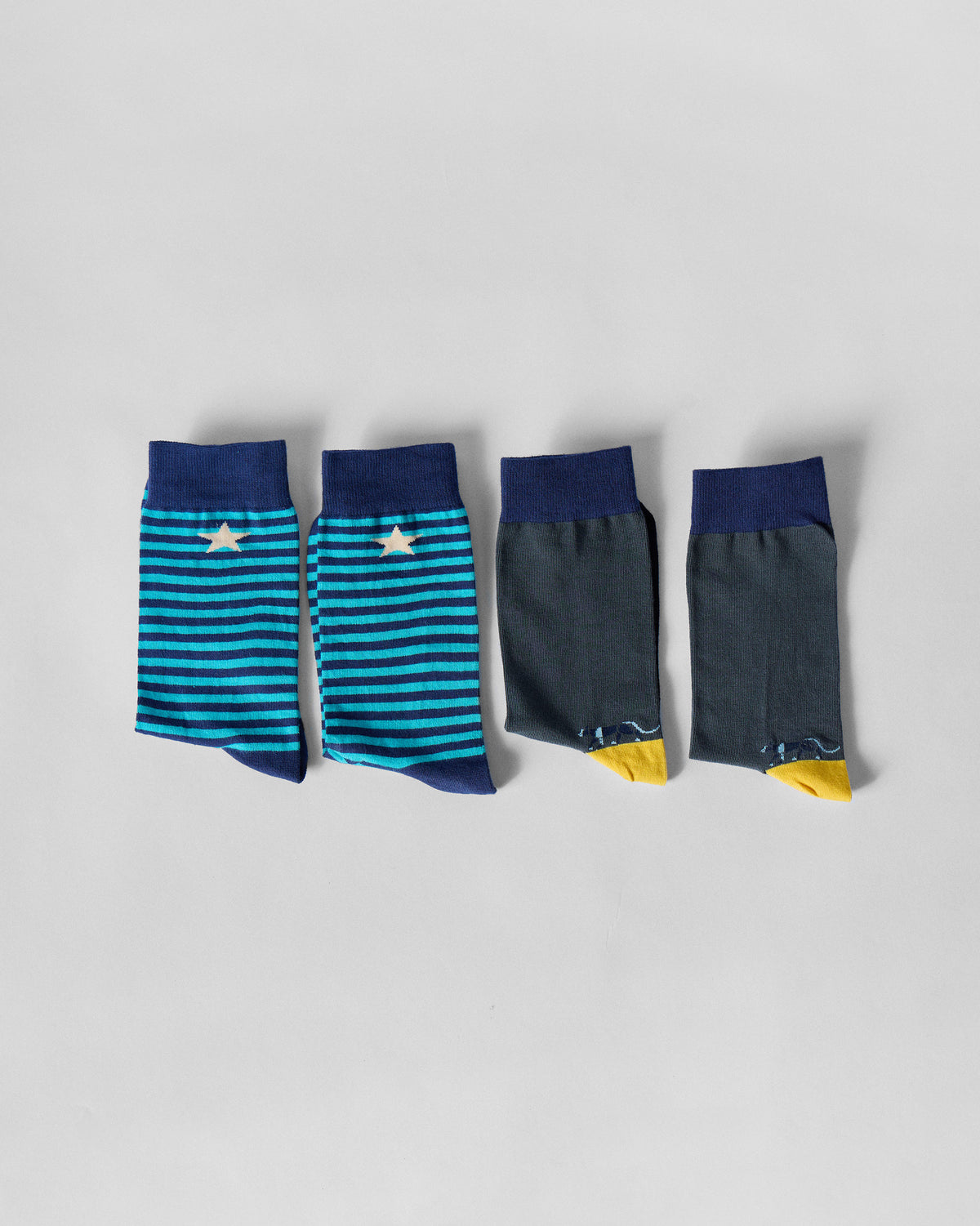 Men's Stride Socks in teal stripes and charcoal with yellow accents.
