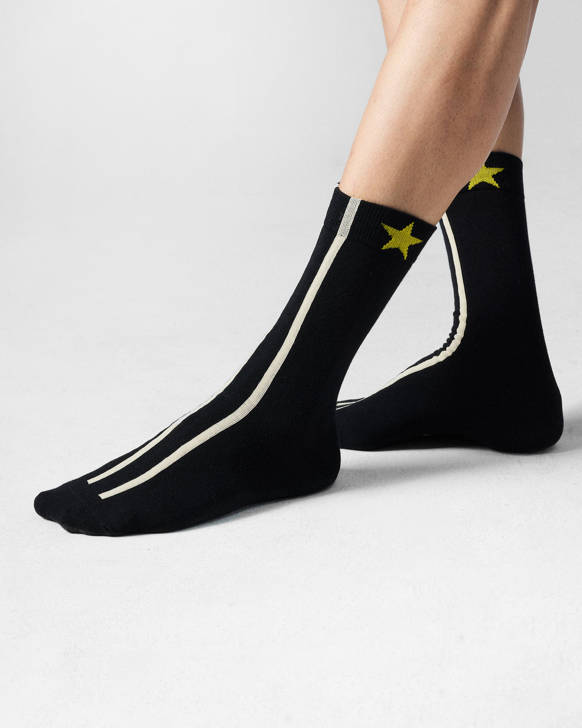 Black Men's Orbit Socks with cream stripes and a yellow star.