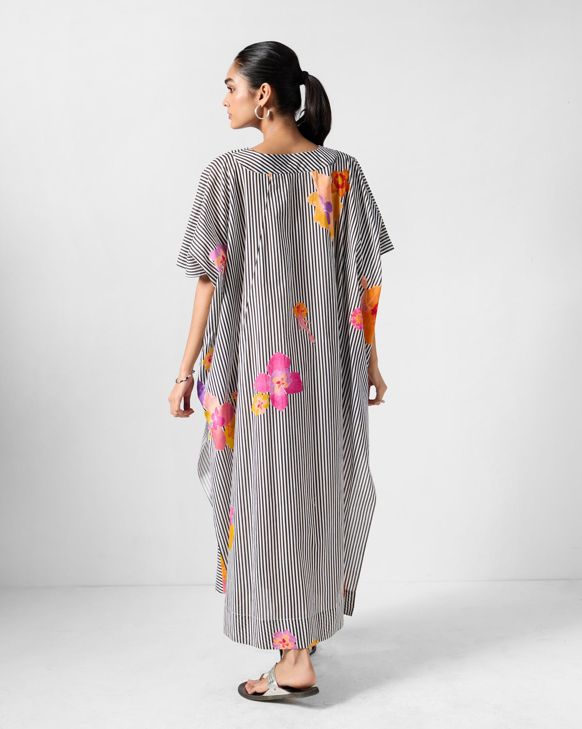 Back of a striped Noa kaftan with pink and orange florals.