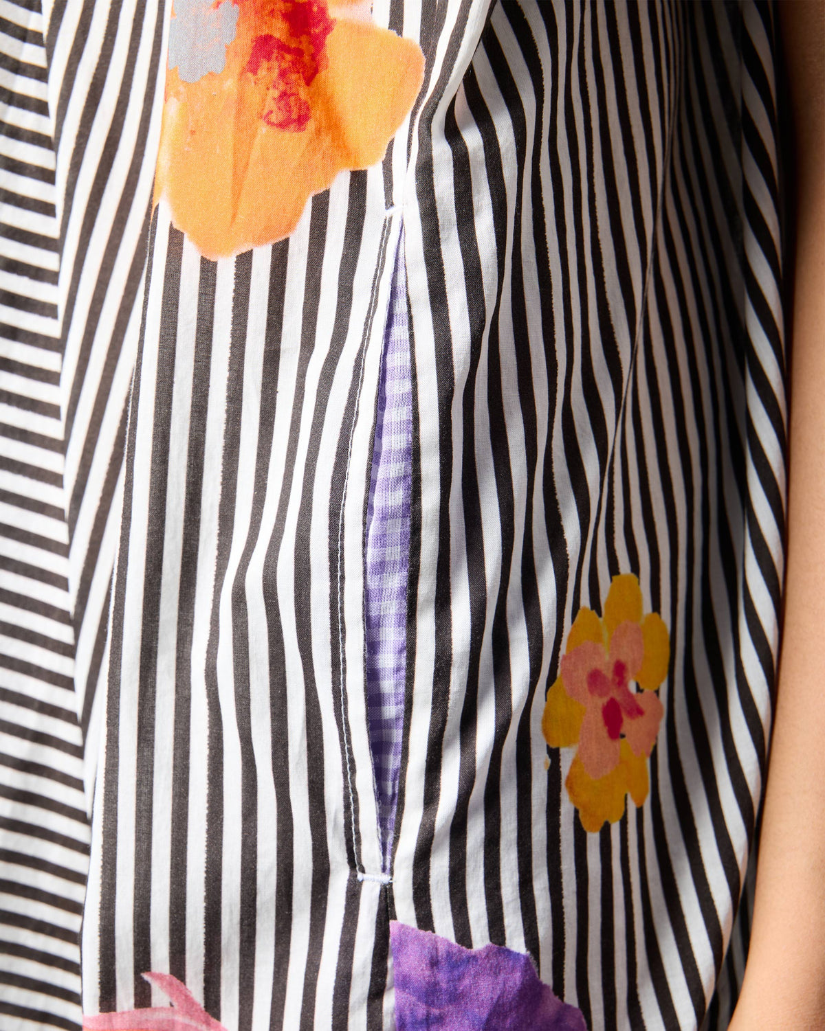 Close-up of a Noa kaftan pocket with purple gingham lining.