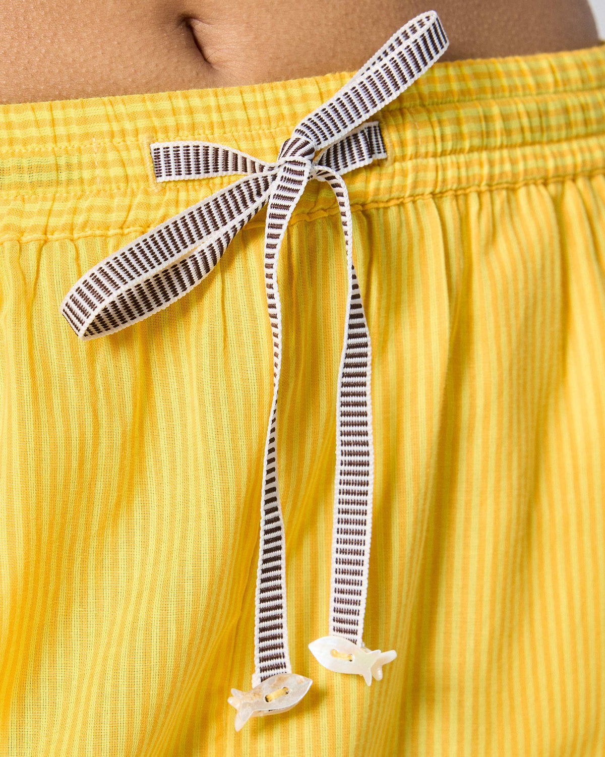Close-up of the drawstring waist on yellow striped Arzoie pants with fish tips.