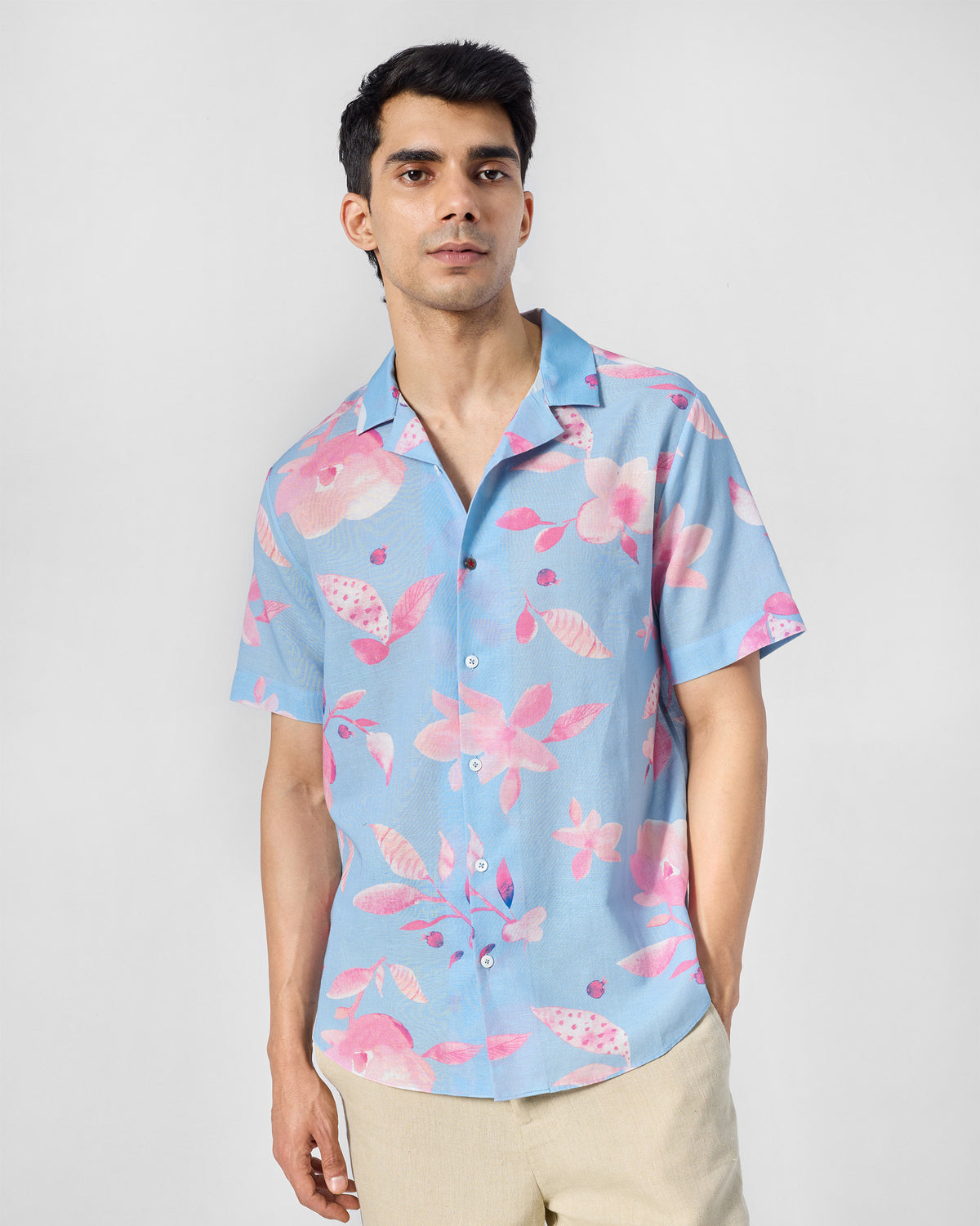 Person wearing a light blue Mistari shirt with pink floral print.