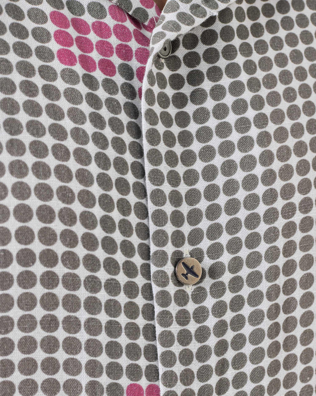 Close-up of a charcoal Mistari shirt placket with polka dots and a plane button.