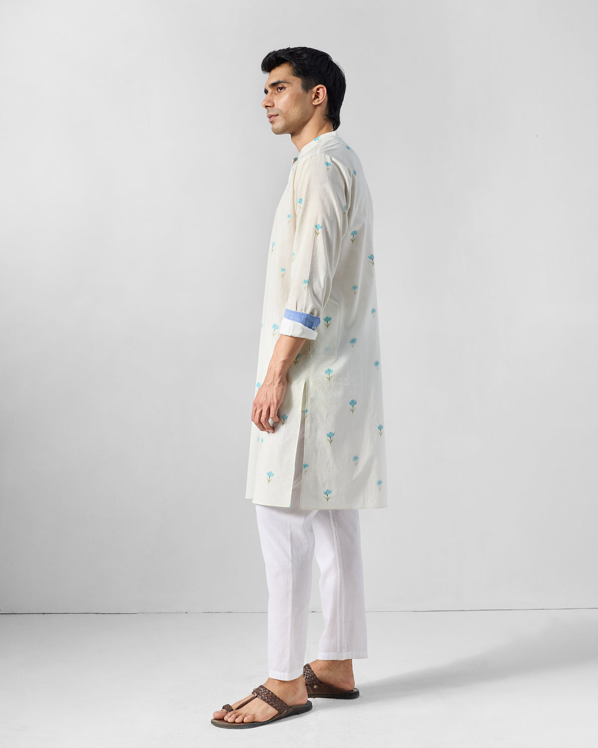 Side view of an ivory Astral kurta with light blue lotus print.