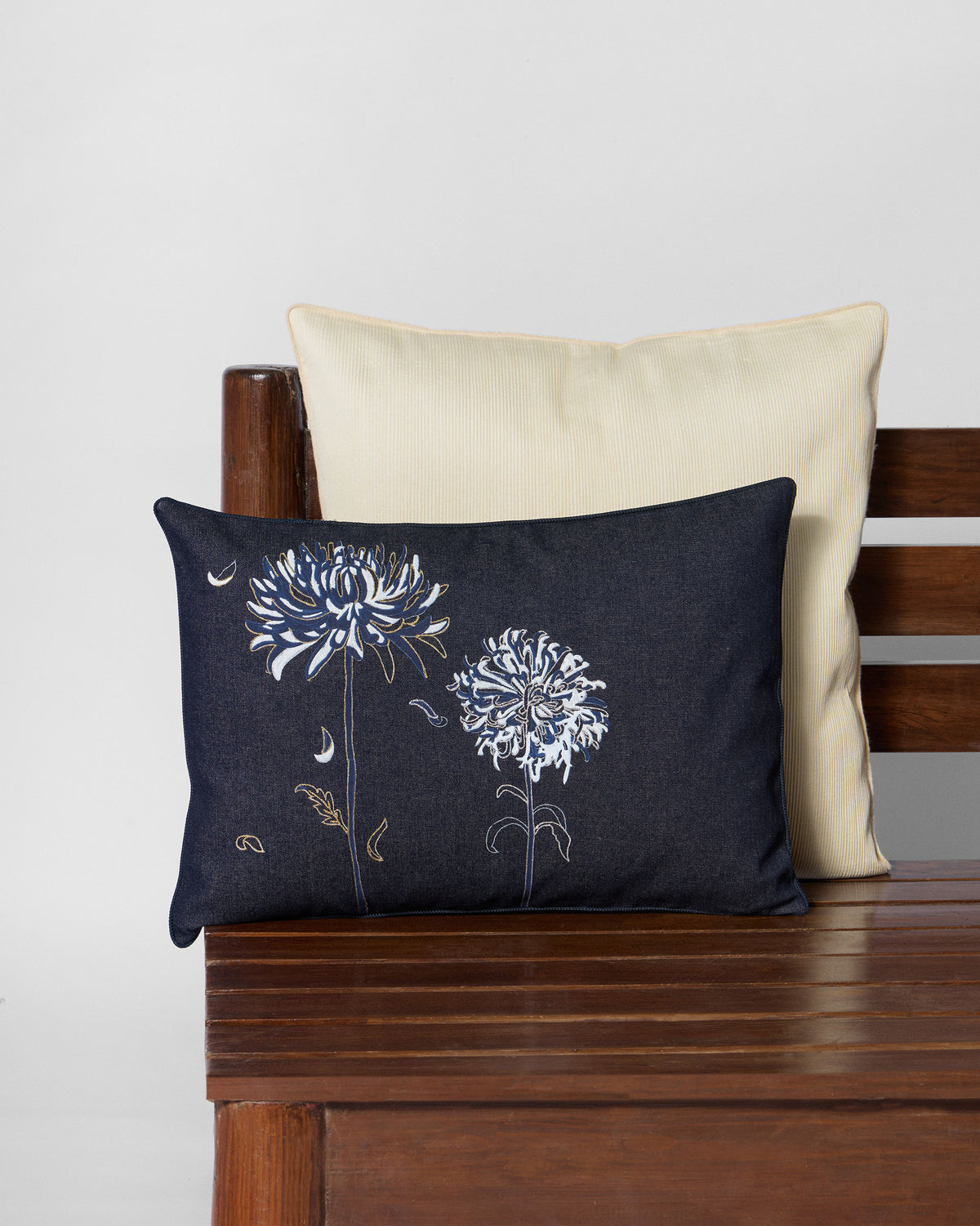 Neelakurinji lumbar cushion with blue and white flowers on a navy background.