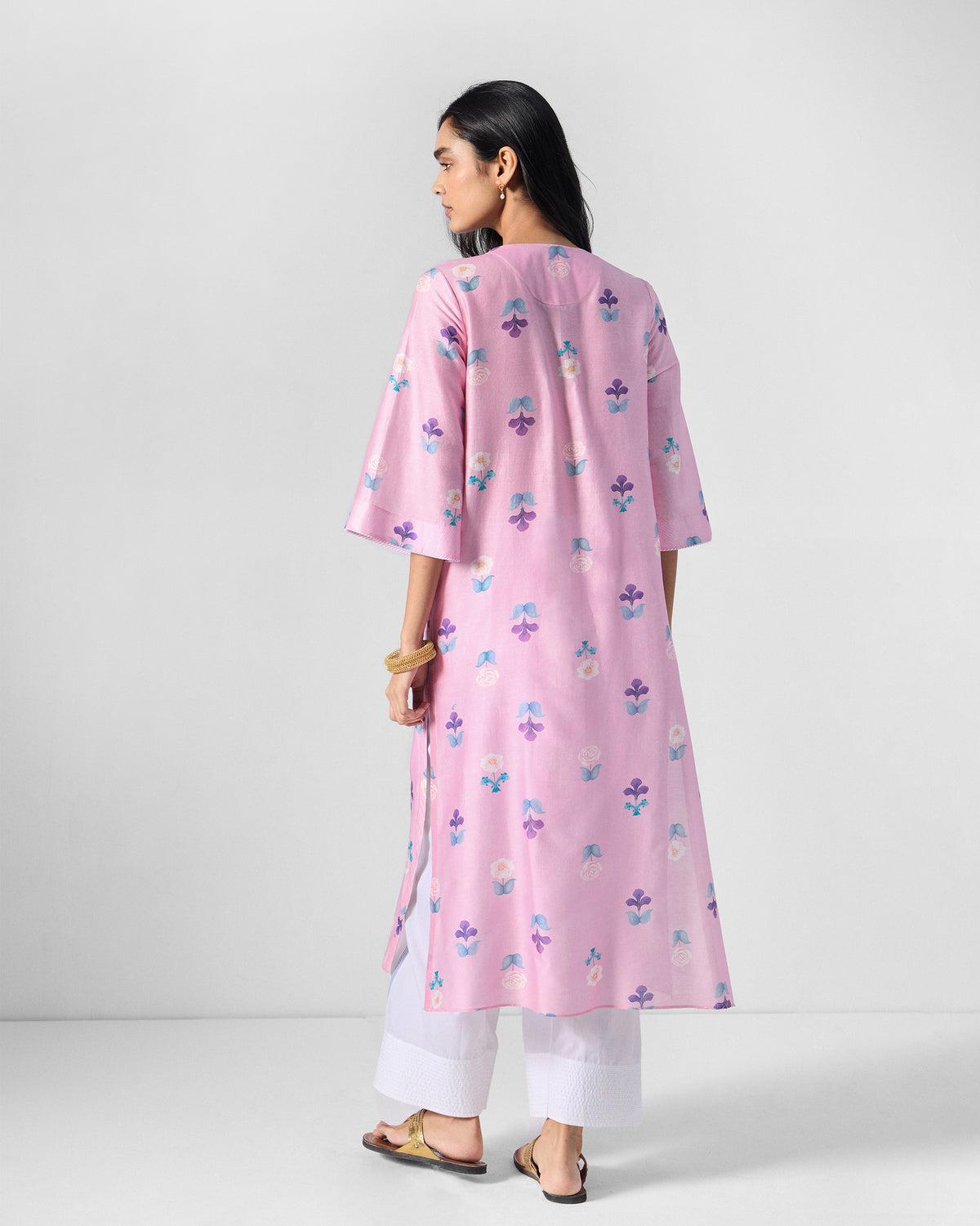 Back of a soft pink floral Hera Kurta showing elbow sleeves and side slits.