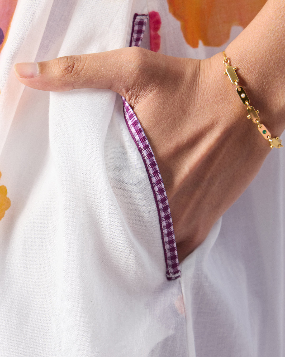Close-up of a purple check pocket trim on an ivory Mirage kurta.