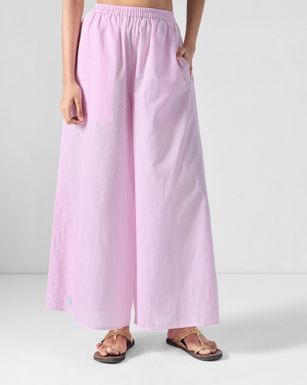 Person wearing pink and white striped Ceylon pants with an elastic waist.