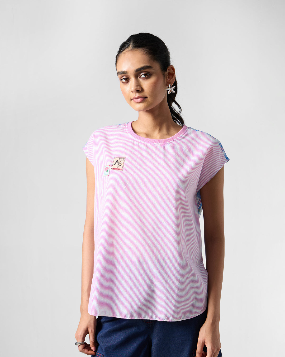 Multicolour Faye top with stamp patches on a pink striped front.