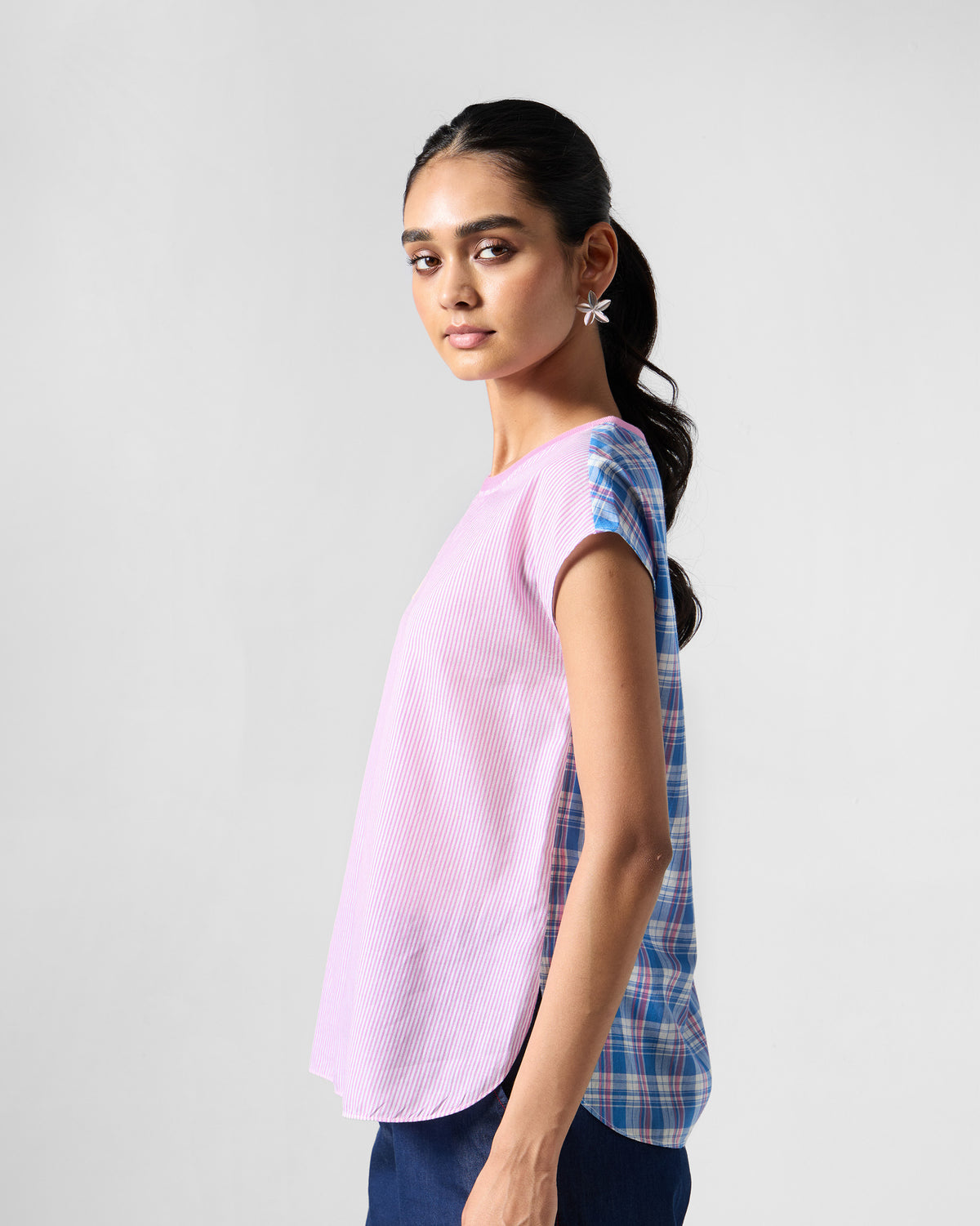 Side view of a multicolour Faye top joining stripe and check panels.