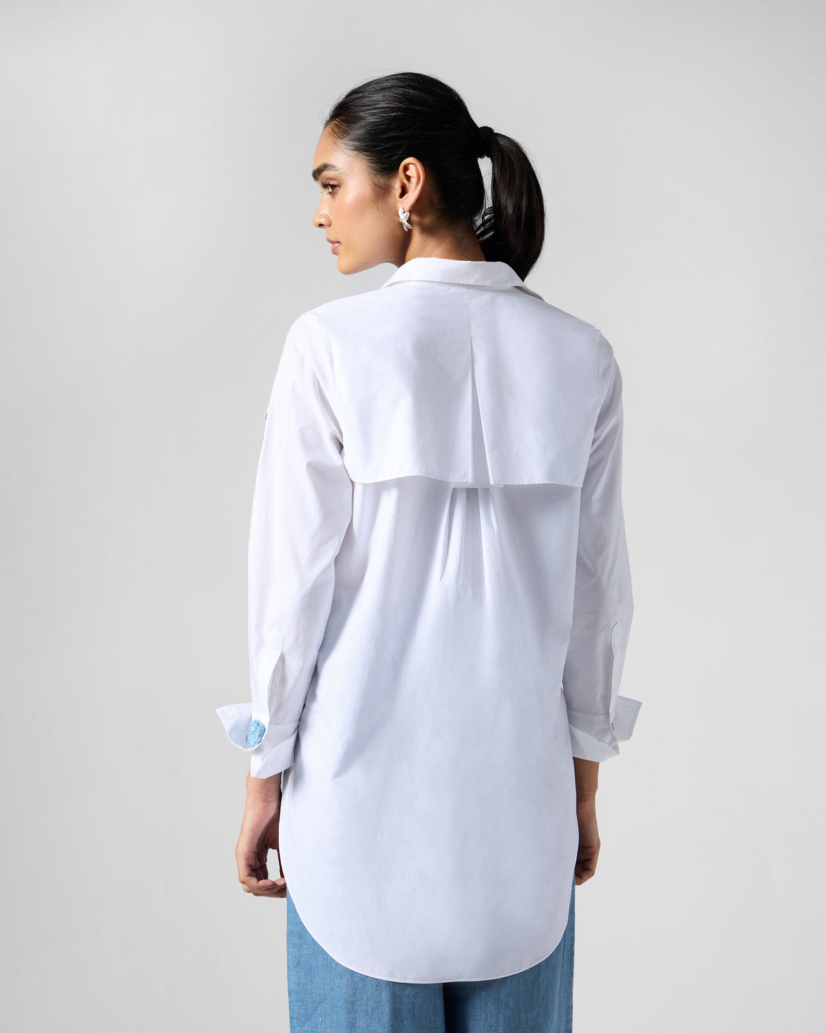Back of a white Trench shirt with a pleated yoke.