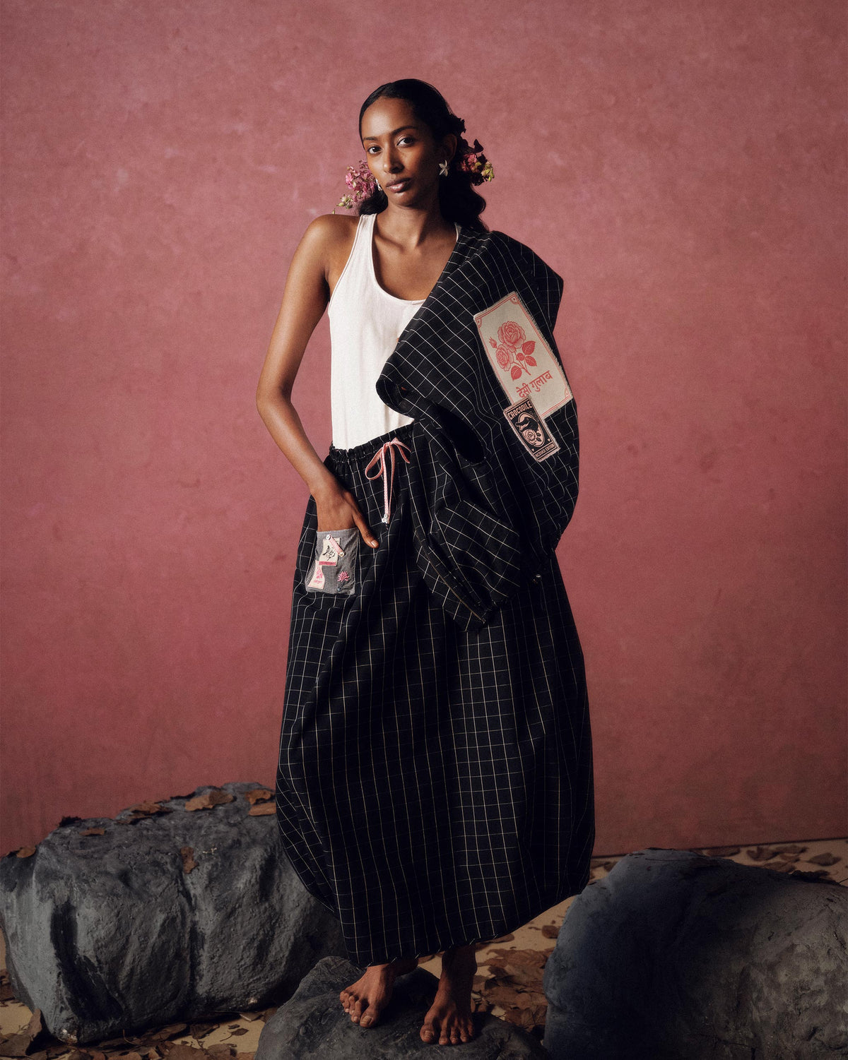 Black-and-white checked Renai top draped over a shoulder showing back patches.