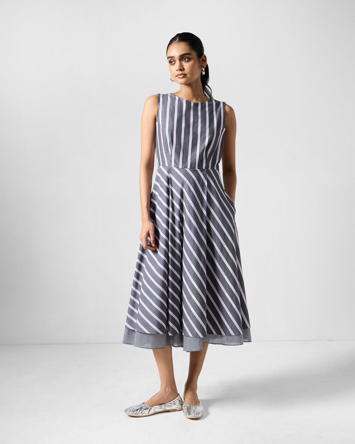 Person wearing a charcoal and pink striped Tapas layered dress.