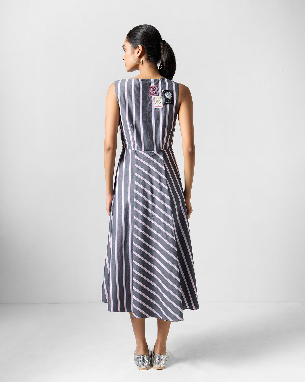 Back of a charcoal and pink striped Tapas layered dress with patches.