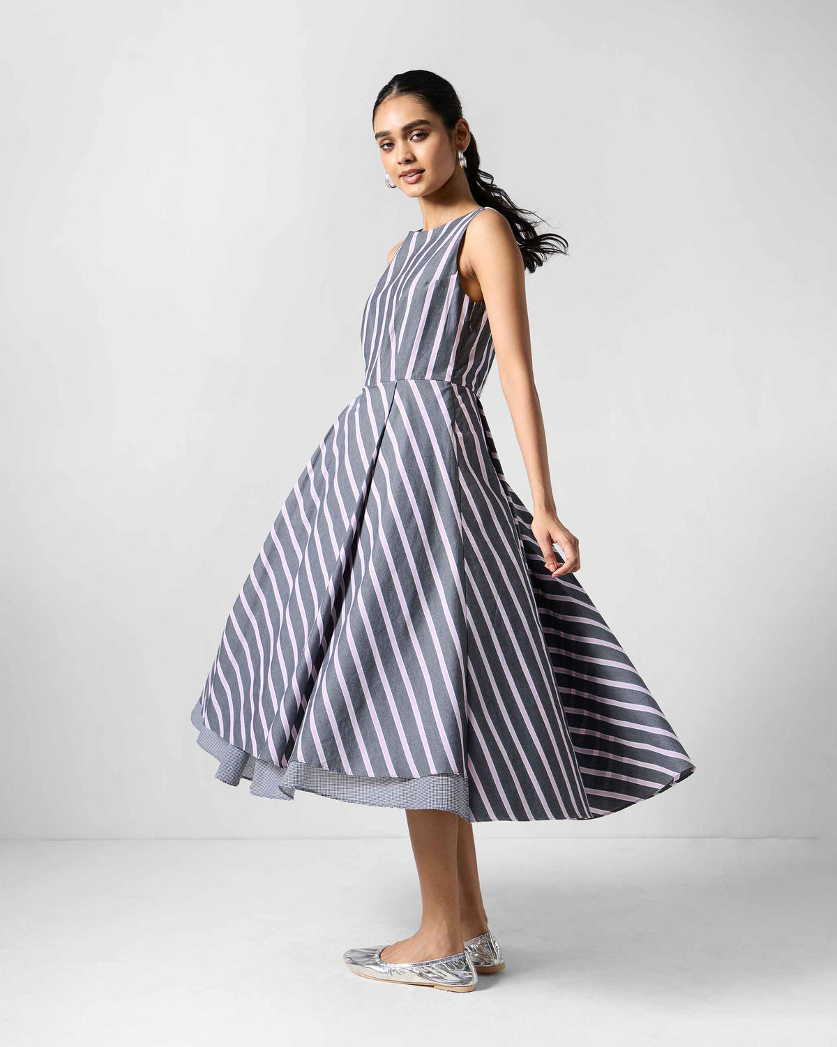 Person wearing a charcoal and pink striped Tapas layered dress.