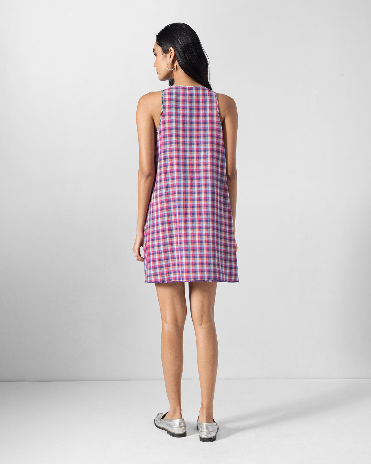 Back of a purple check Daye reversible dress worn by a person.