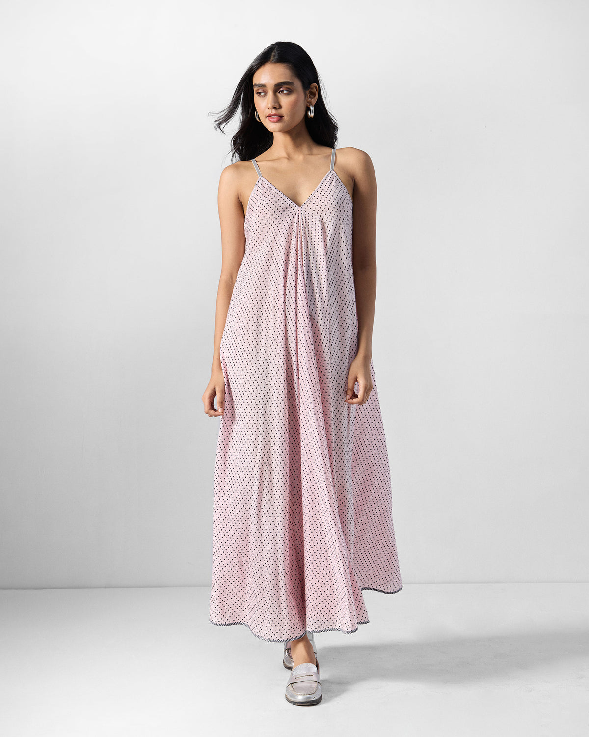 Person wearing a pink and charcoal printed V-neck strappy maxi dress.