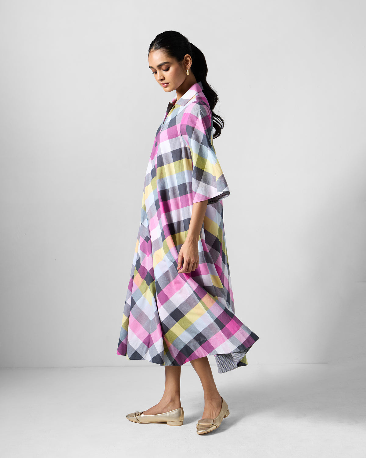 Side view of a multicolour check Areva A-Line Dress with flared elbow sleeves.