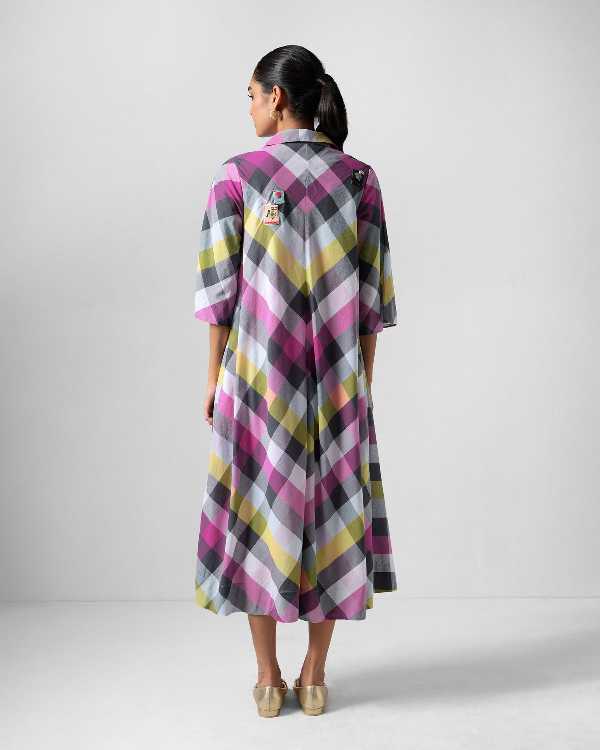 Back of a multicolour check Areva A-Line Dress with a center seam chevron.