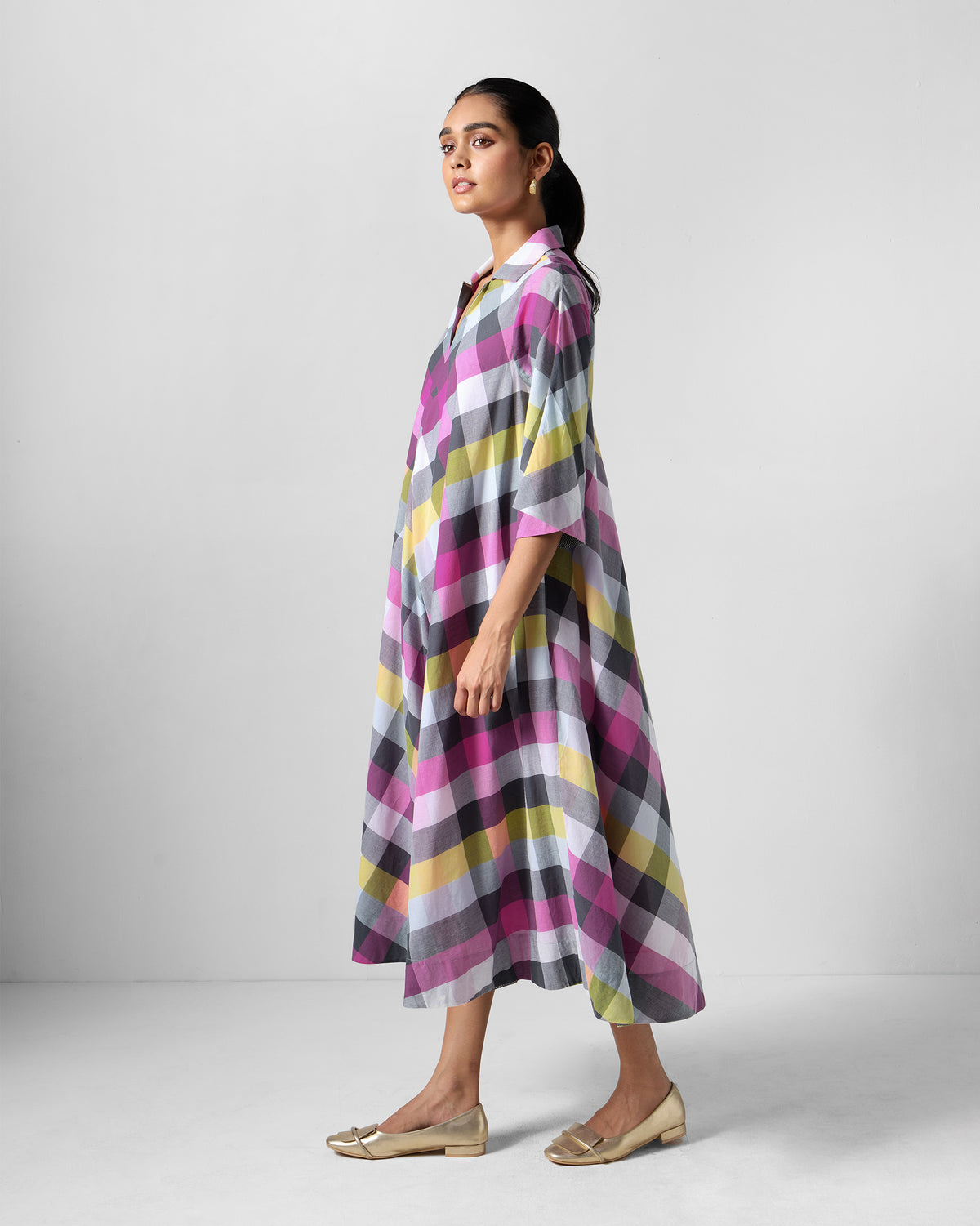 Person wearing a multicolour check Areva A-Line Dress at a three-quarter angle.