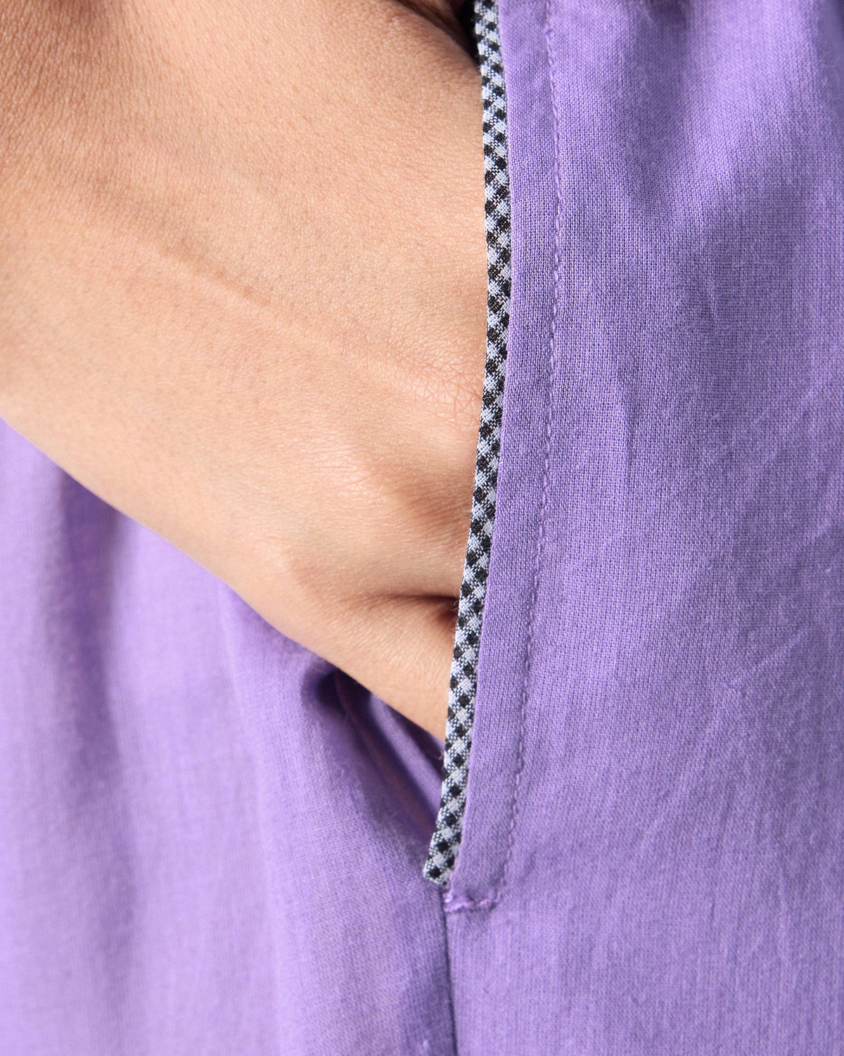 Close-up of a side pocket with checkered trim on lilac Kinatra Pants.