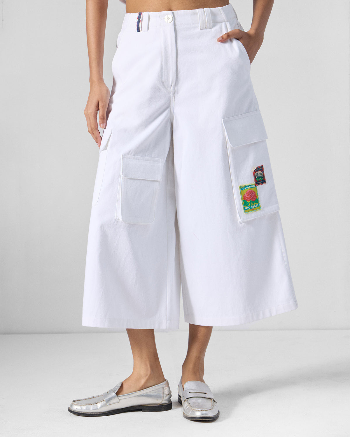 White Ella culottes with wide cropped legs and patched cargo pockets.