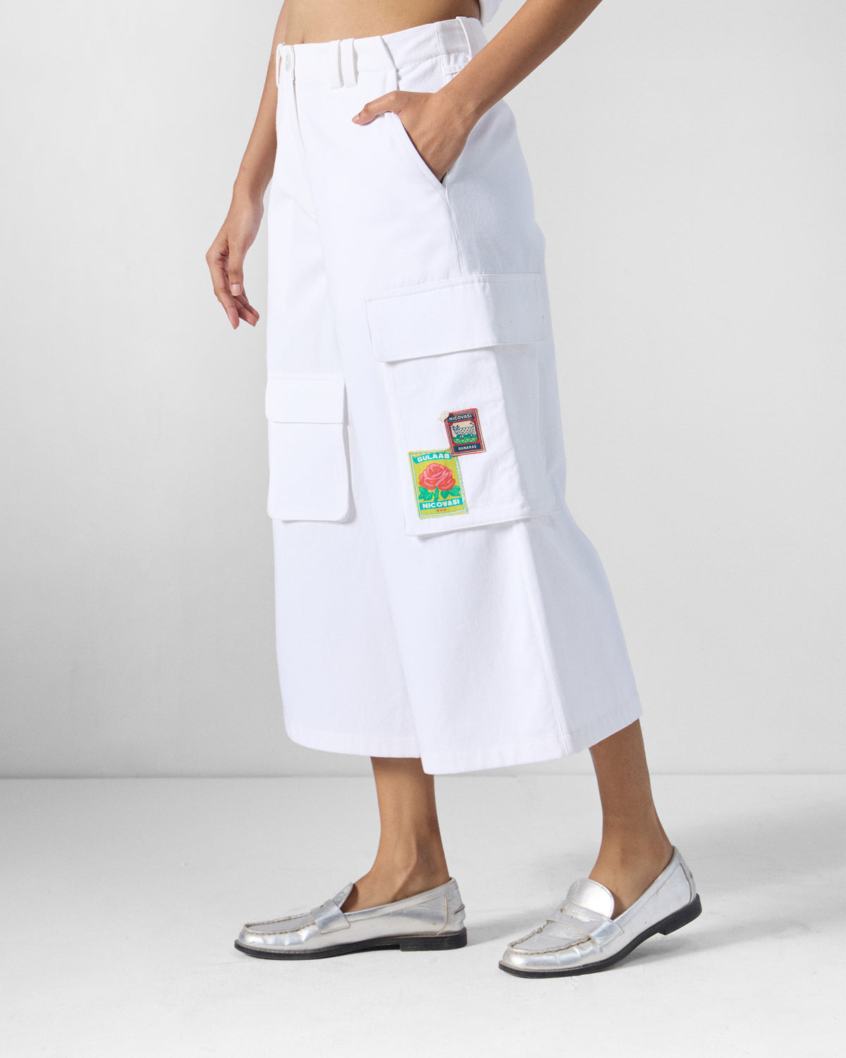 Side view of white Ella culottes showing a cargo pocket with a gulab patch.