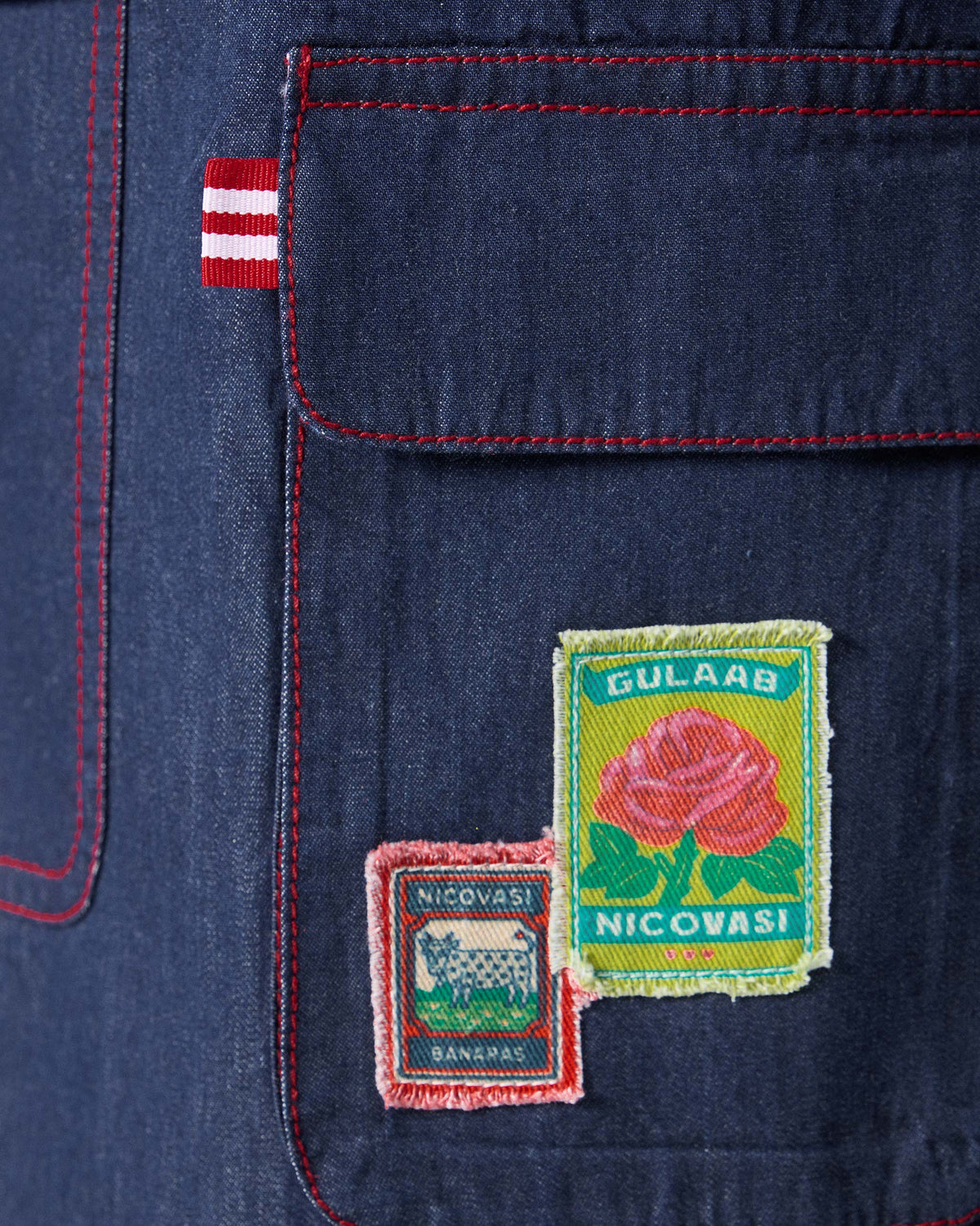 Close-up of gulab and Banaras patches on a blue Ella culottes cargo pocket.
