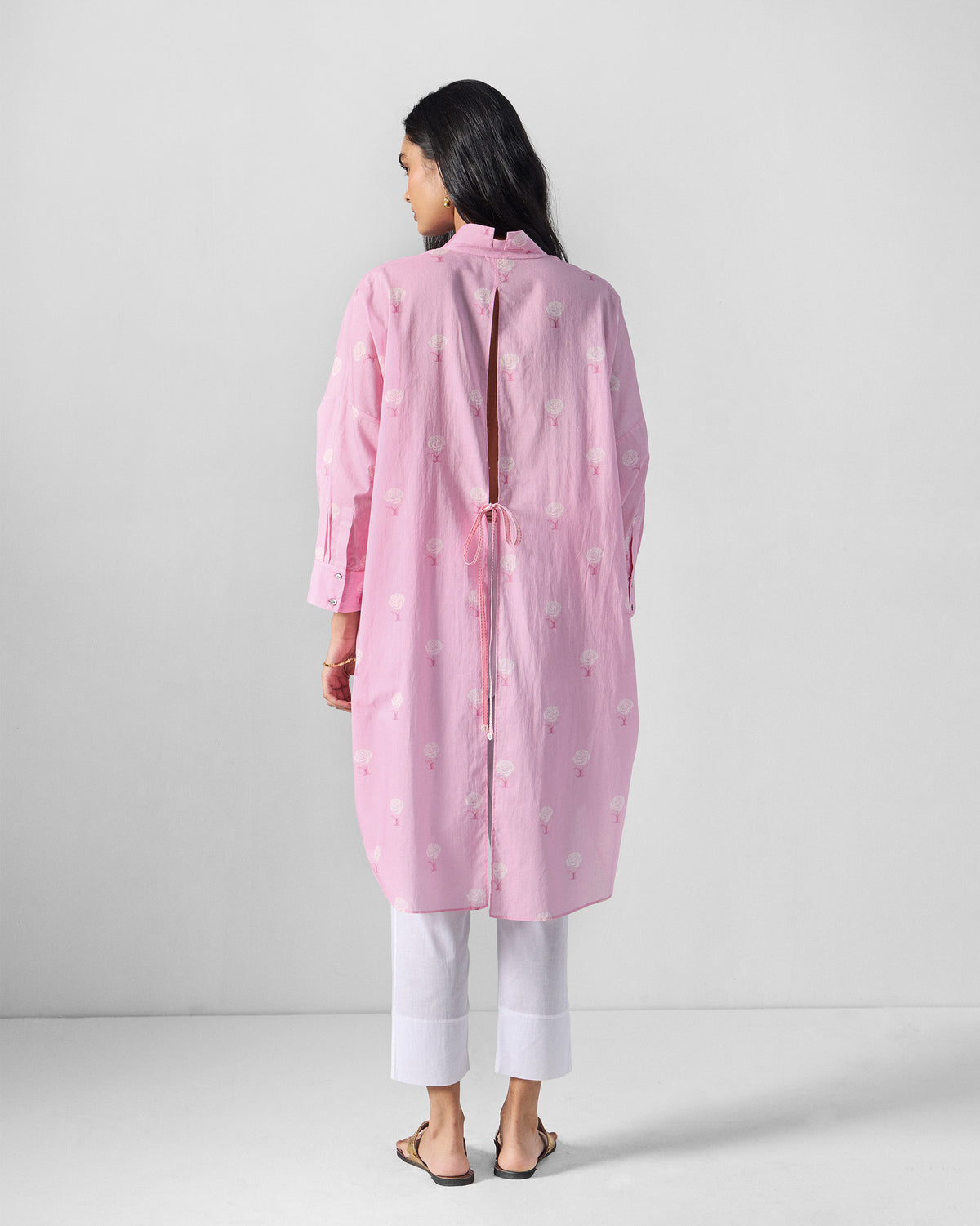 Back of a soft pink Raha tunic with a slit and tie.