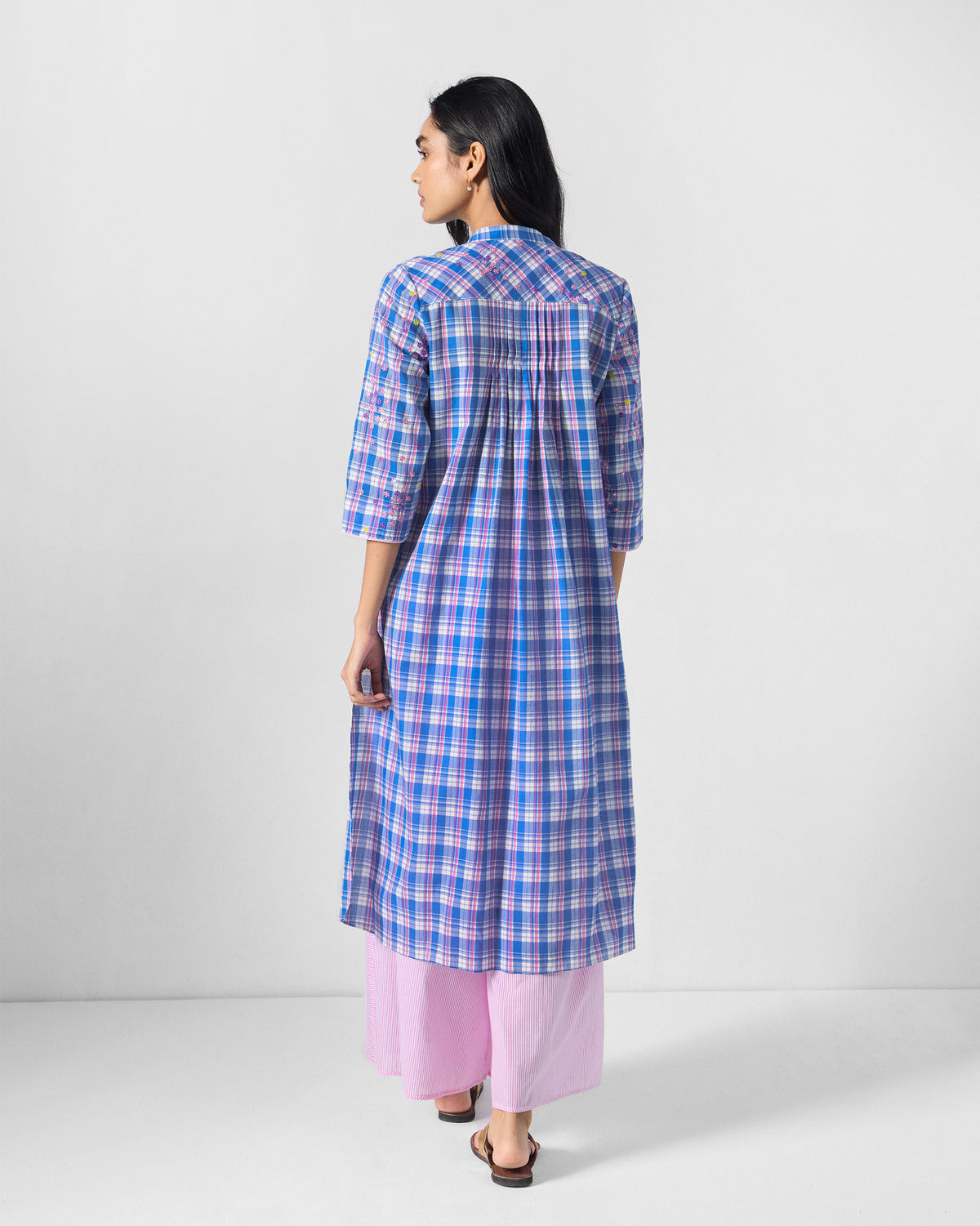 Back of a blue check Eka Kurta with pink floral embroidery and pin-tucks.